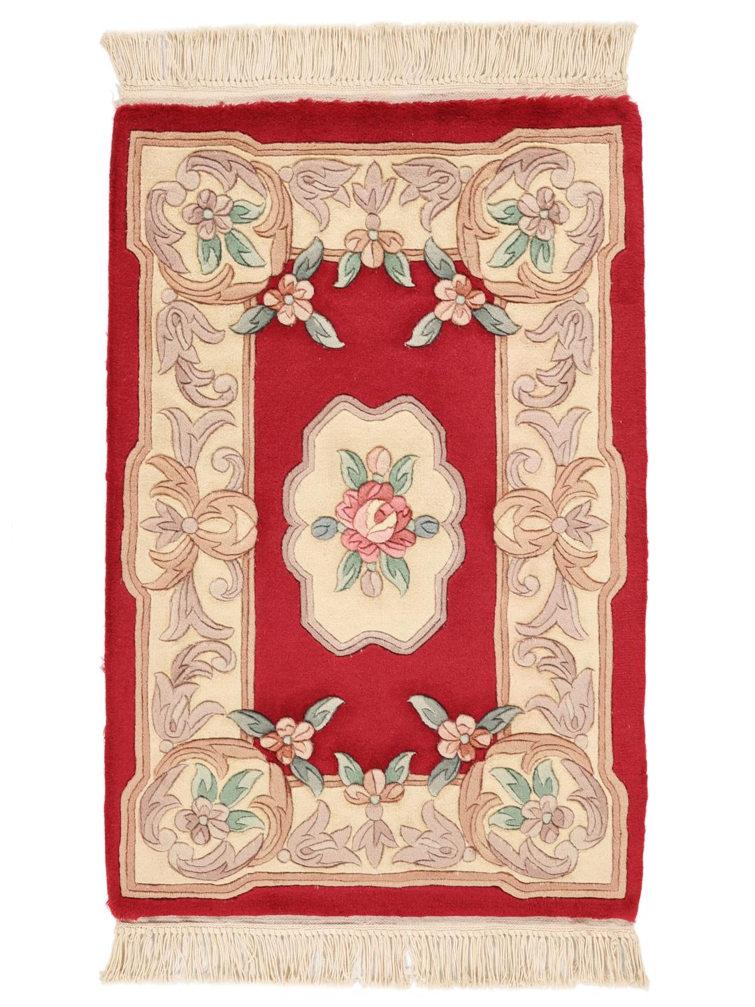 Hand-knotted rug from China with a red background and floral patterns