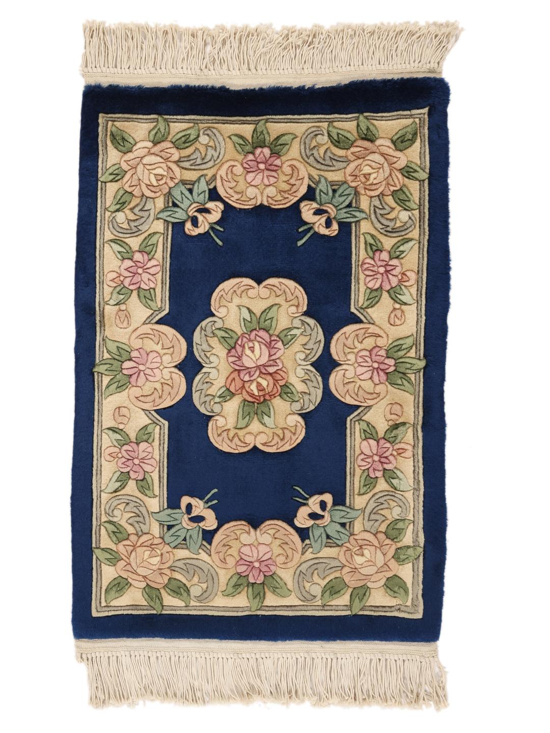 Hand-knotted Chinese rug featuring a floral pattern on a deep blue background