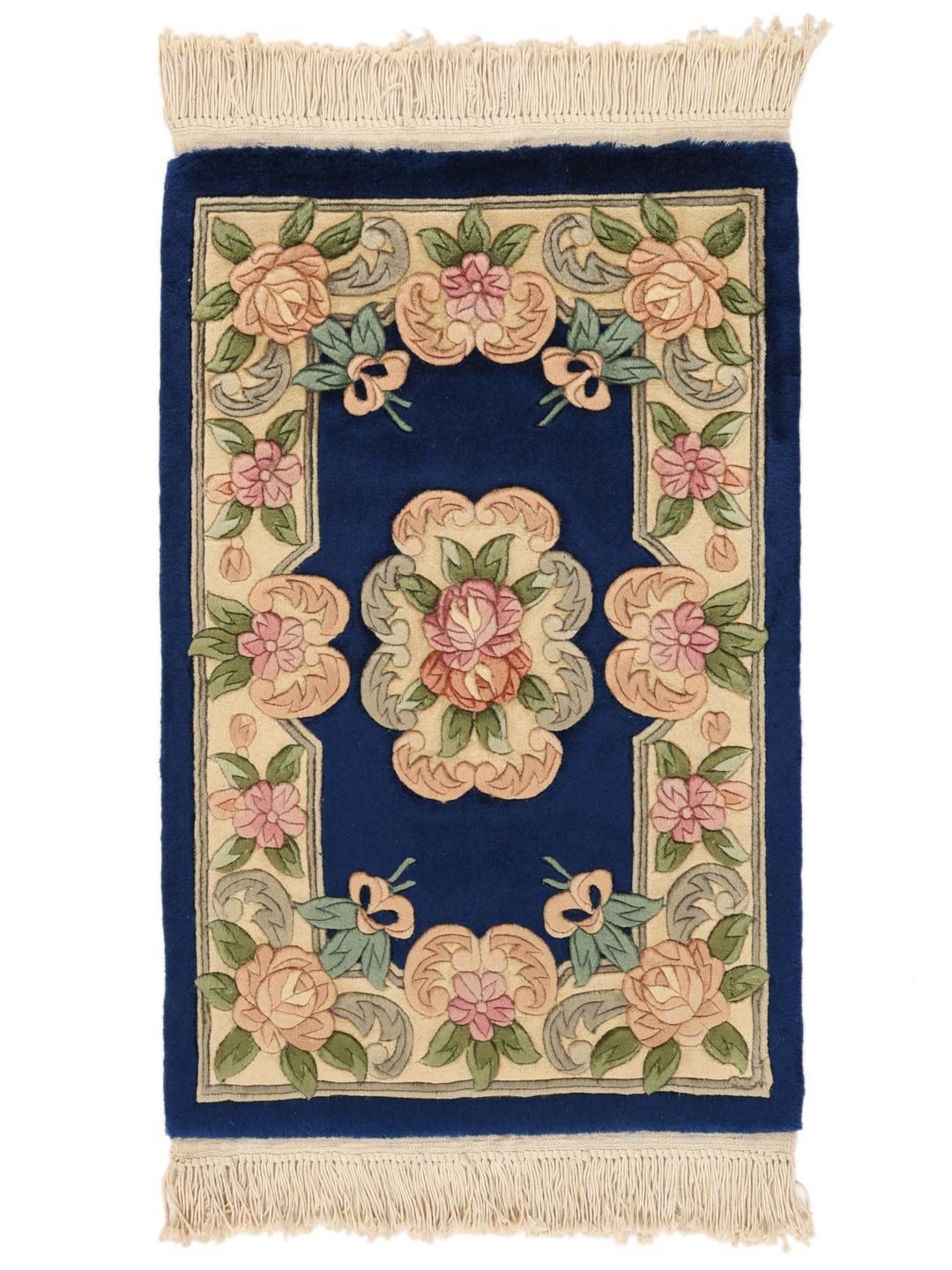 Hand-knotted Chinese rug with floral motifs in blue and soft pastel tones.