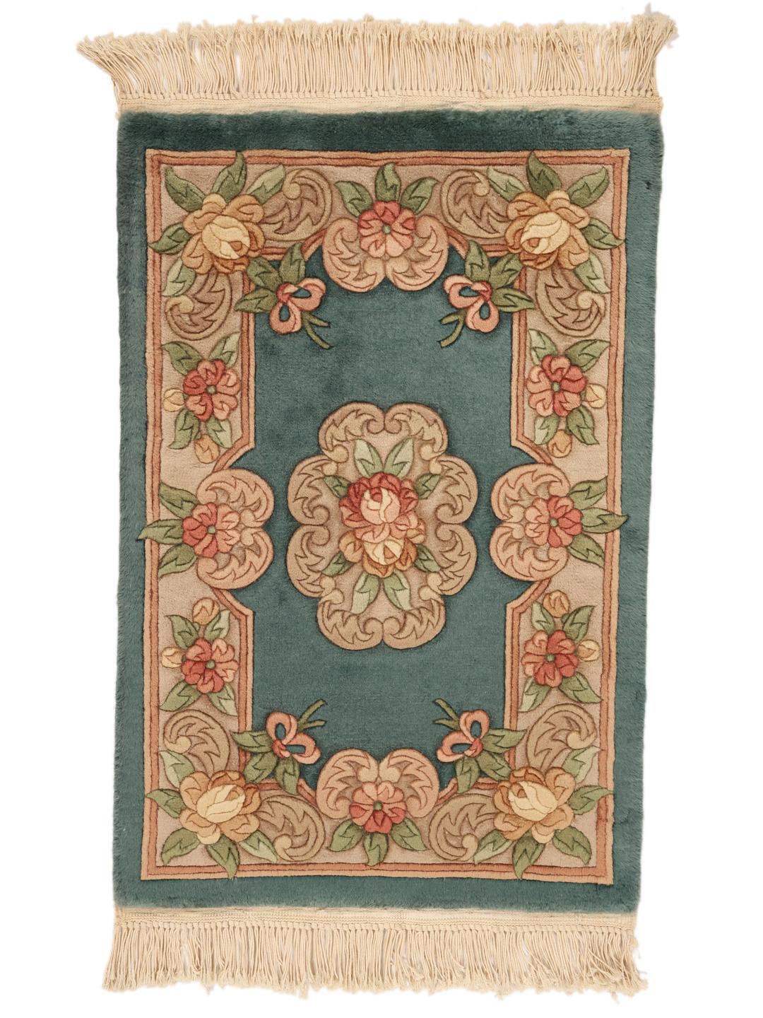 A small, one-of-a-kind Chinese hand-knotted rug with a teal background and floral patterns.