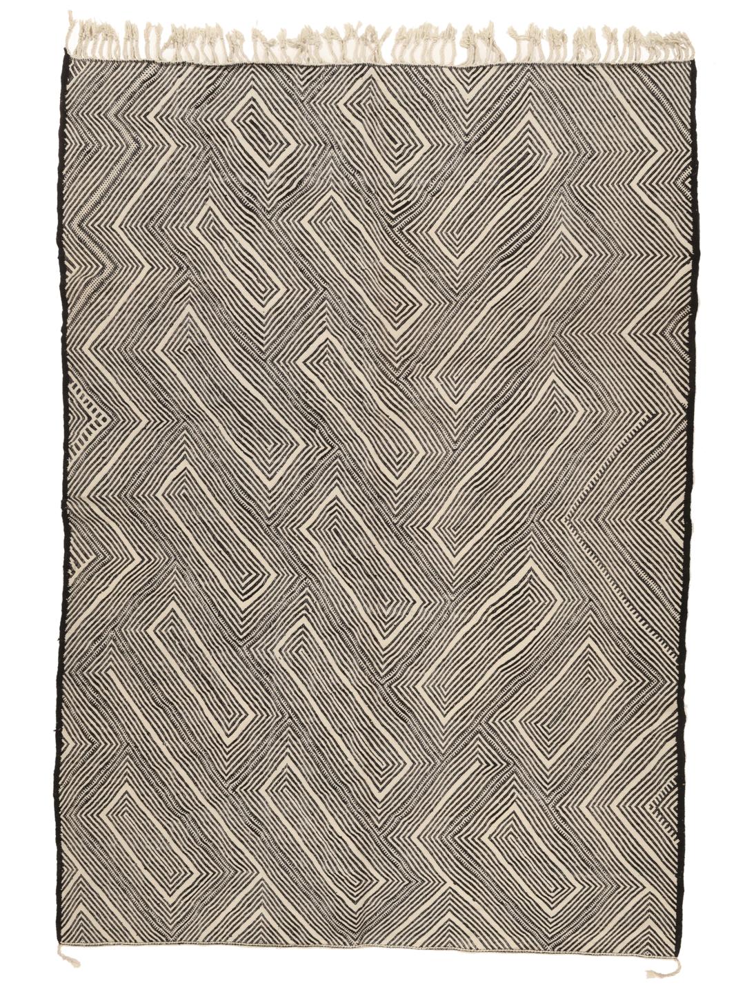 Hand-woven Moroccan High Atlas rug with geometric black and off-white patterns.