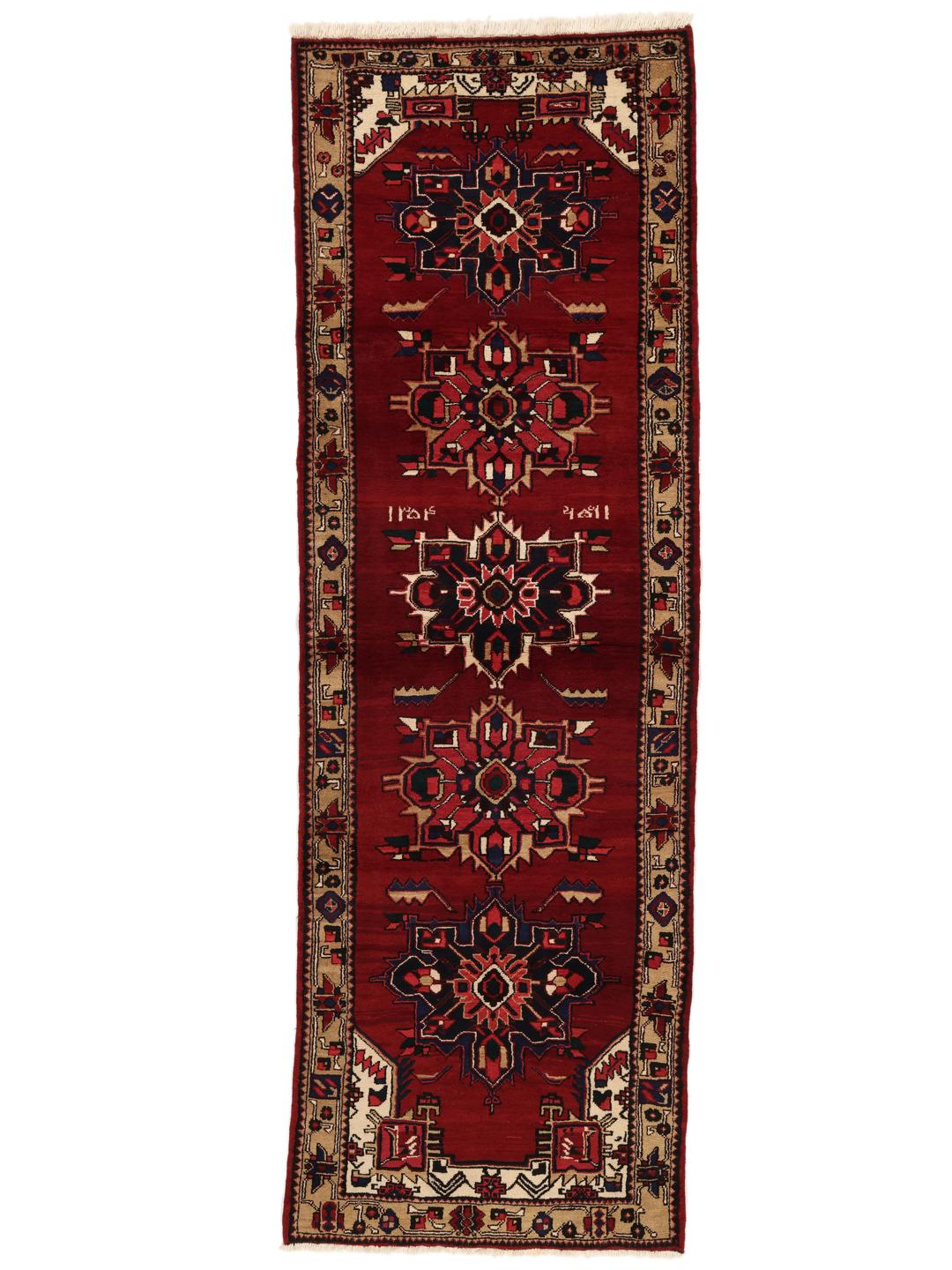 A hand-knotted Hamadan runner with traditional geometric red motifs