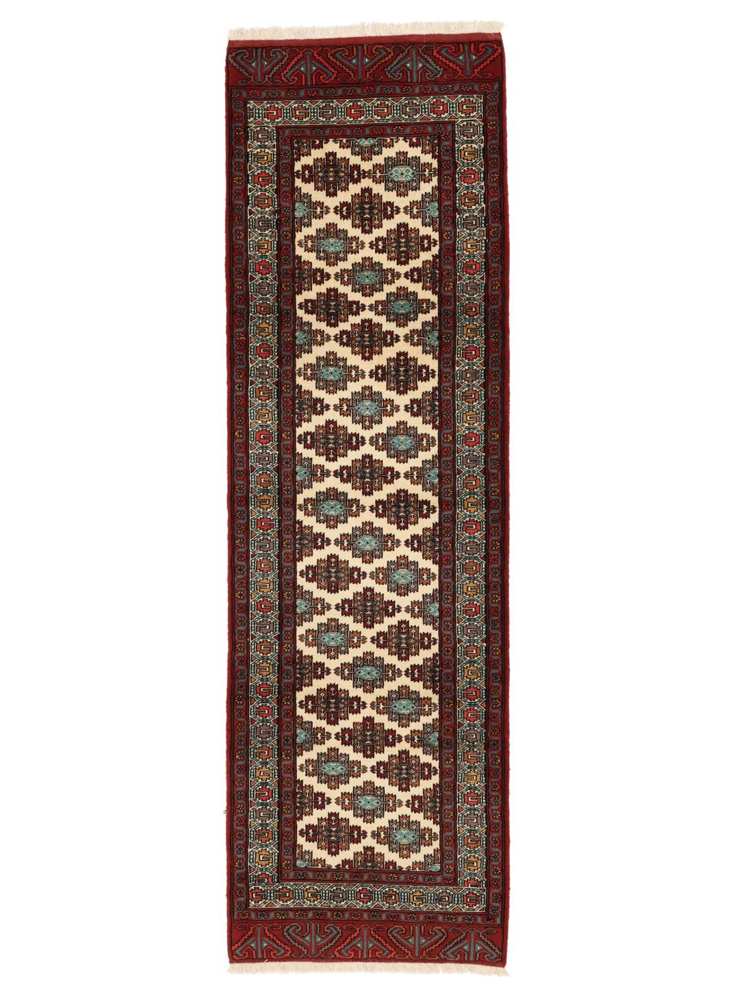 Hand-knotted Turkaman runner rug from the Middle East in red and beige tones.