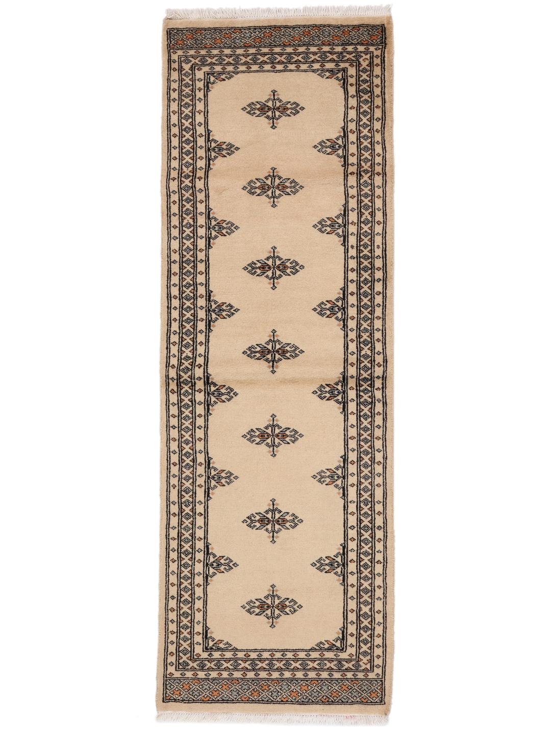 A hand-knotted Pakistani runner rug in beige with a traditional tribal pattern.