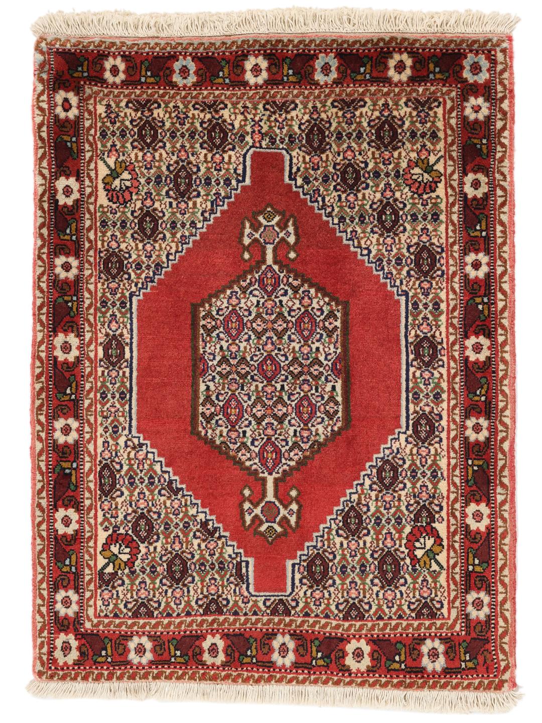 A hand-knotted Senneh rug from the Middle East in vibrant red tones.