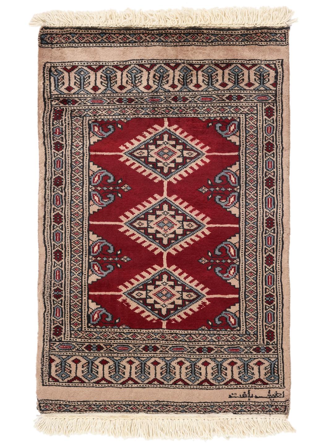 A hand-knotted Pakistan Bokhara rug in red and beige tones with traditional geometric motifs.