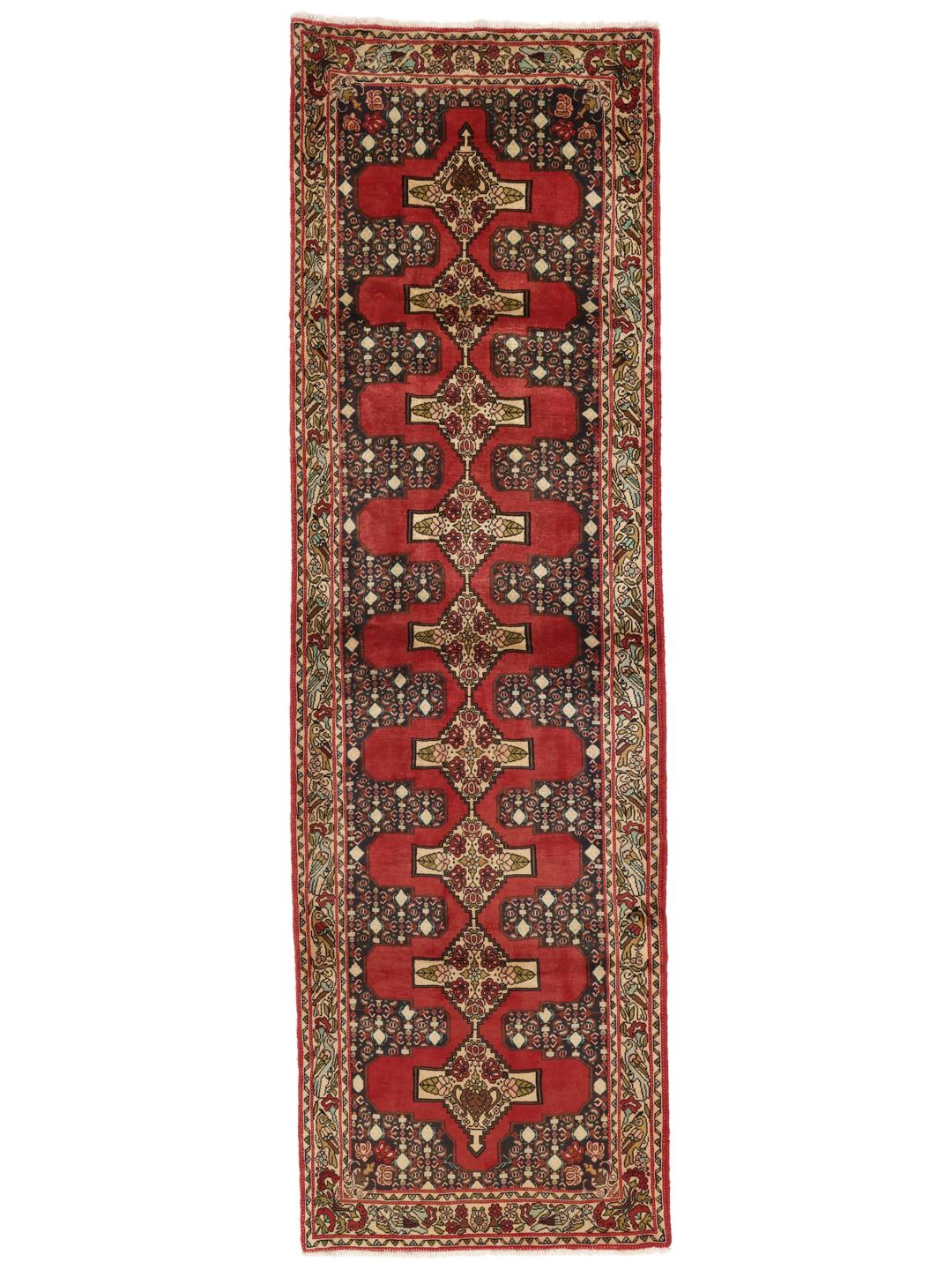 Hand-knotted Senneh runner from the Middle East in shades of red and dark blue.