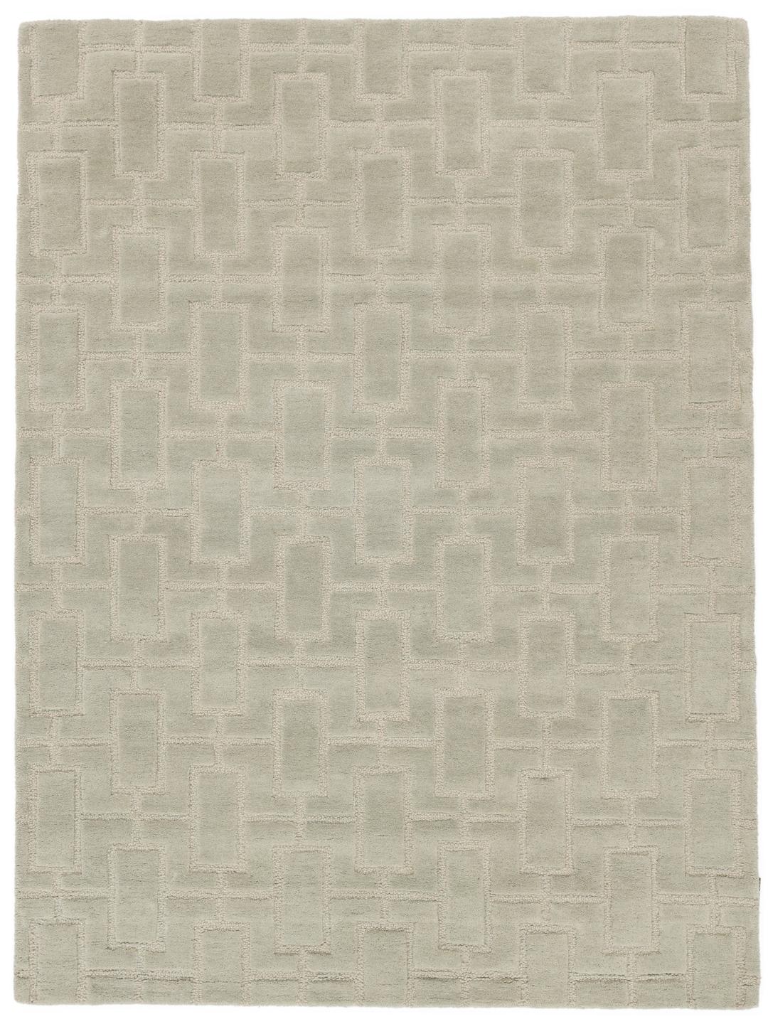 Green rug with a geometric high and low pile texture