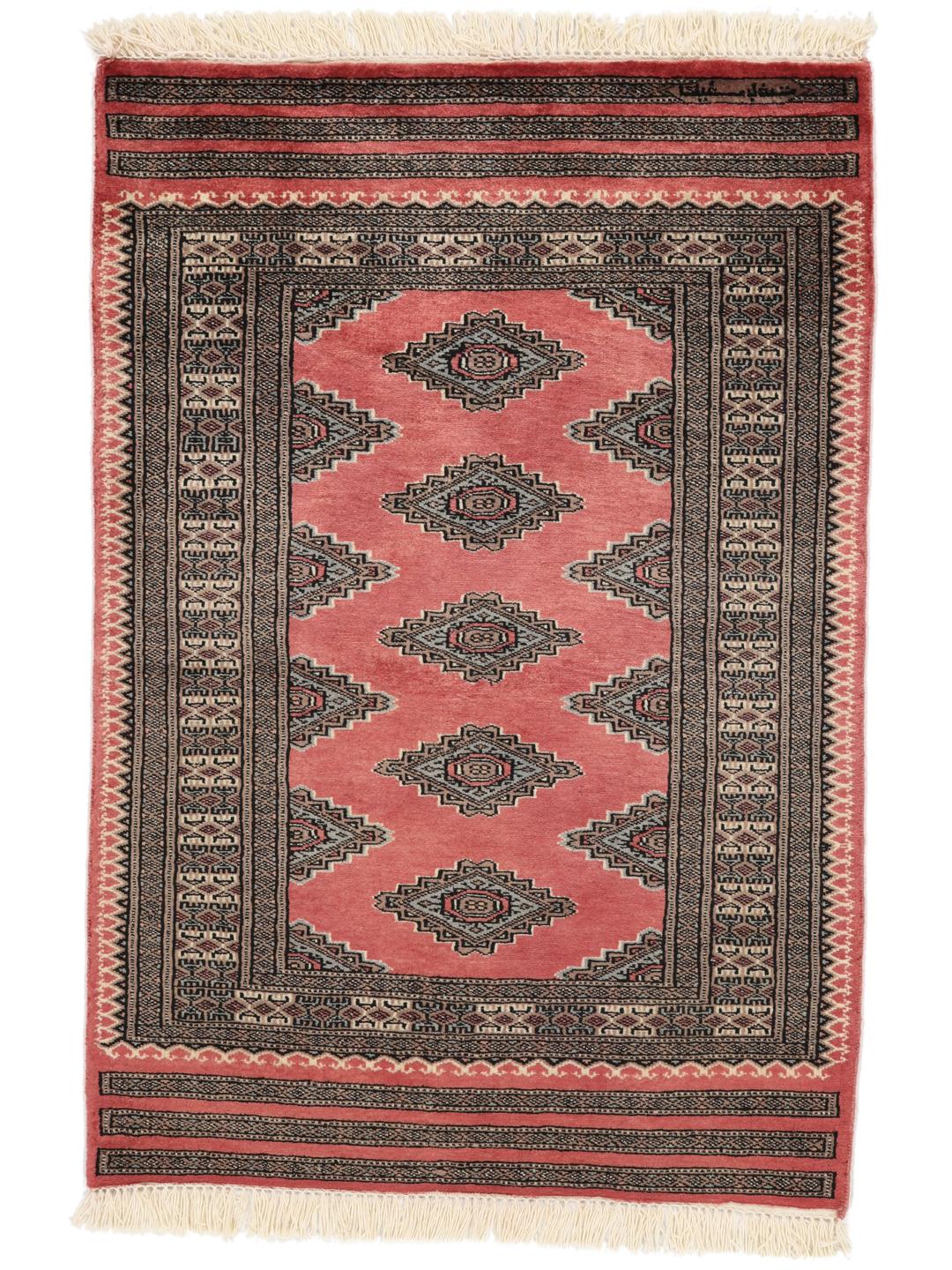 A hand-knotted red Pakistan Bokhara rug with traditional geometric motifs.