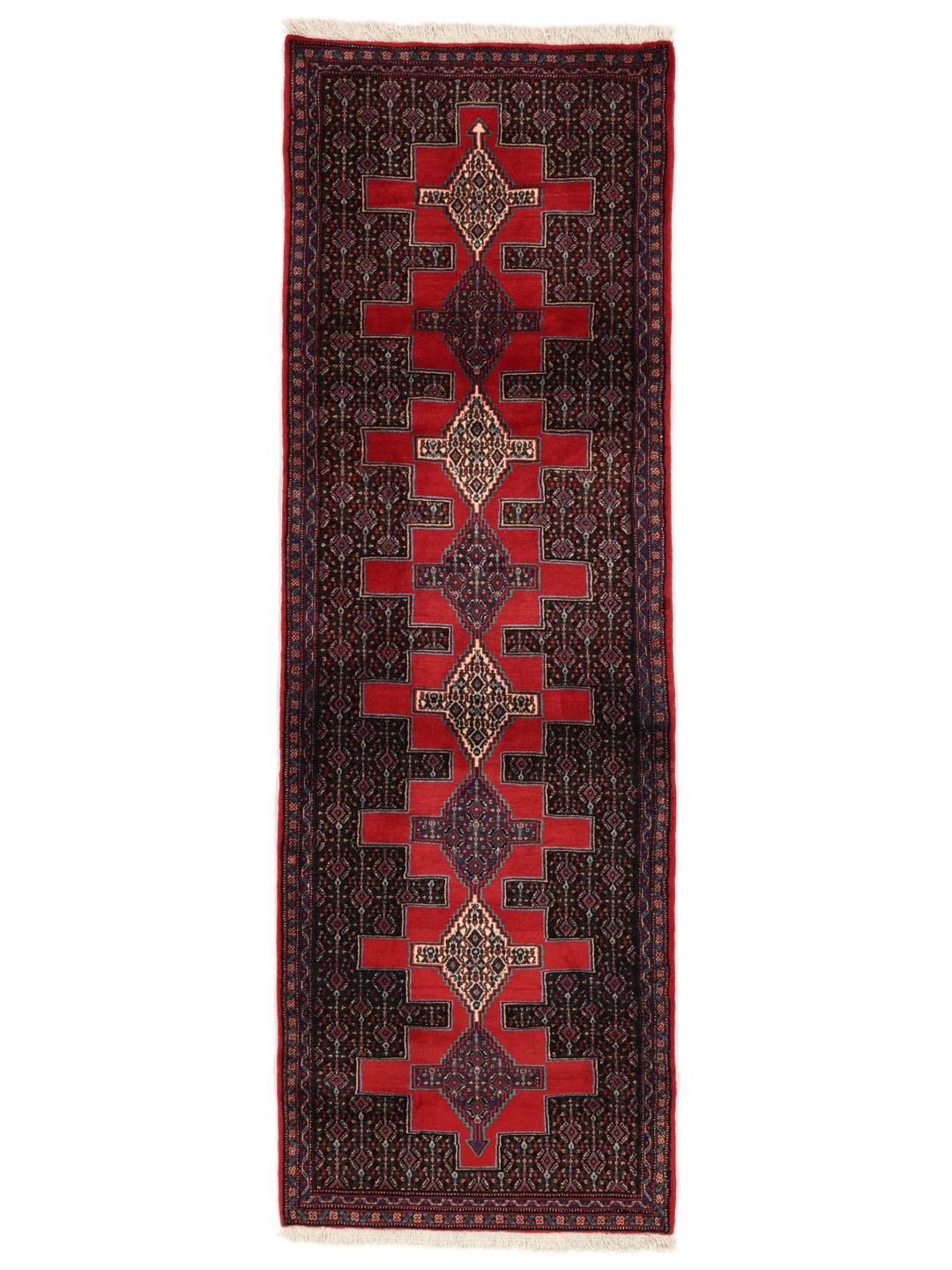 A hand-knotted Senneh runner from the Middle East in dark-red and black tones.