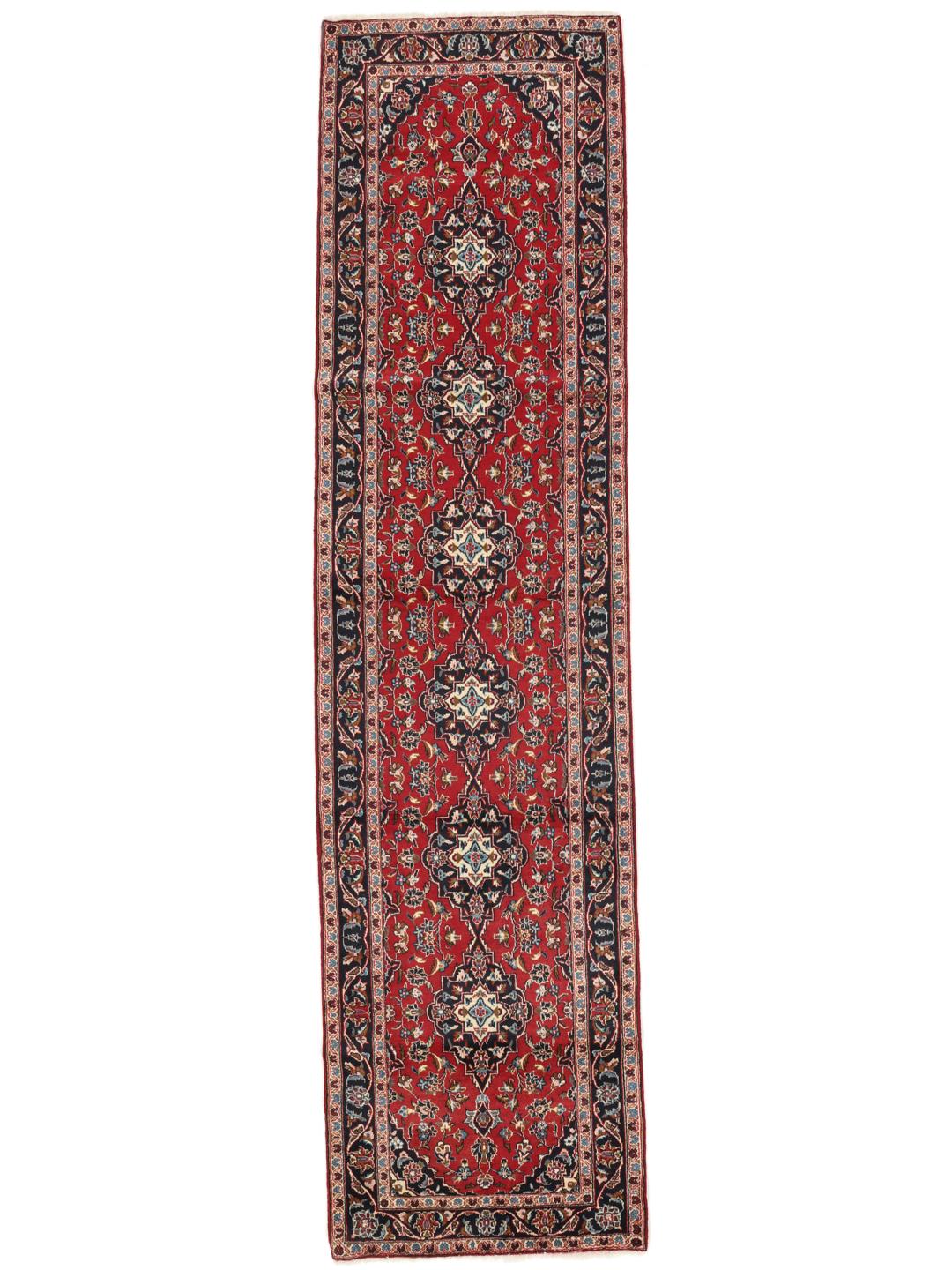 Hand-knotted Keshan runner rug with a classic floral medallion design in red and blue.