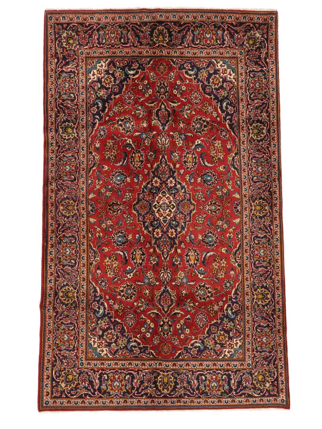 A hand-knotted Keshan rug in red and blue tones from the Middle East.