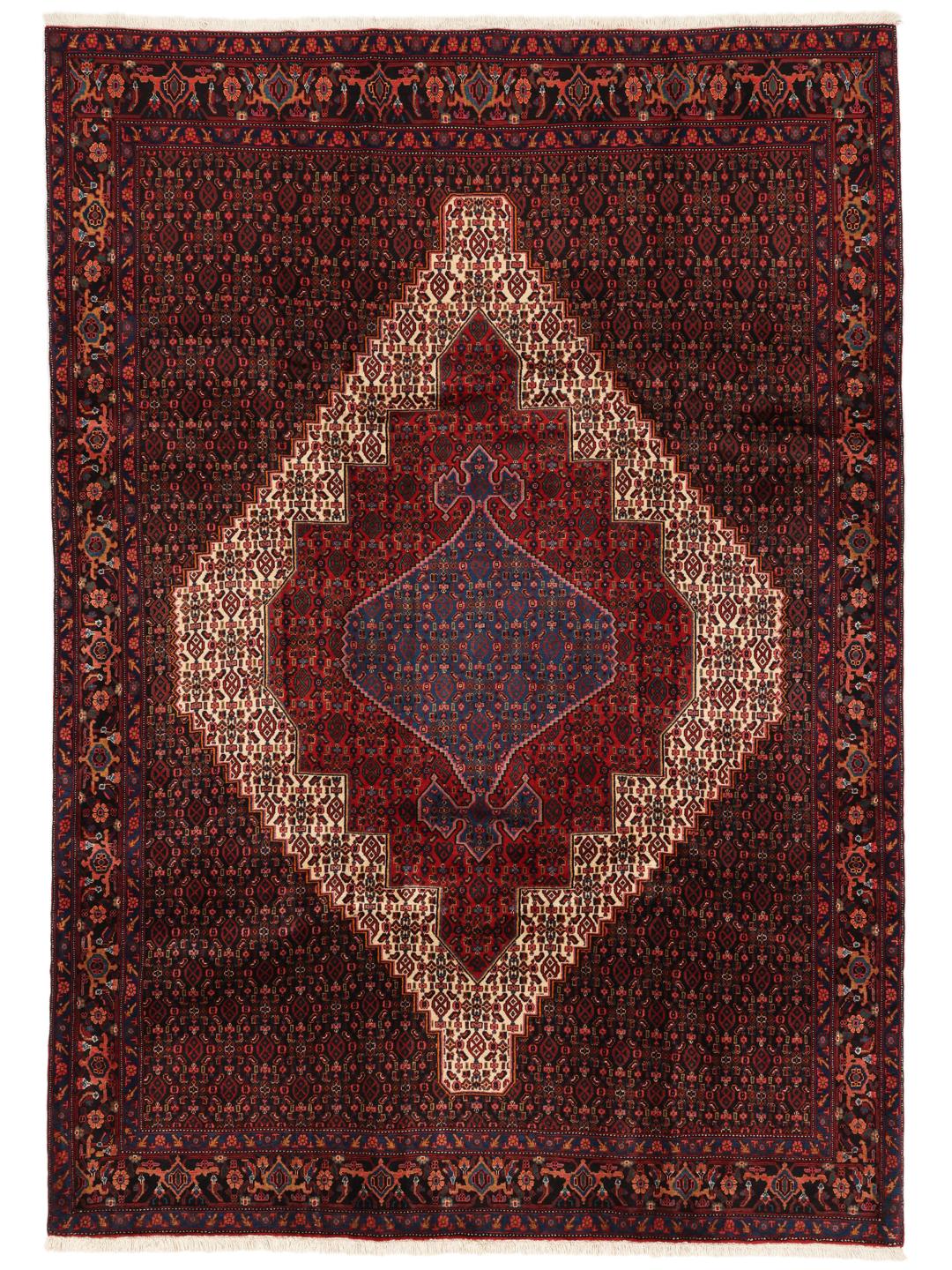 A hand-knotted Senneh rug from the Middle East featuring a dark-red and blue medallion design.