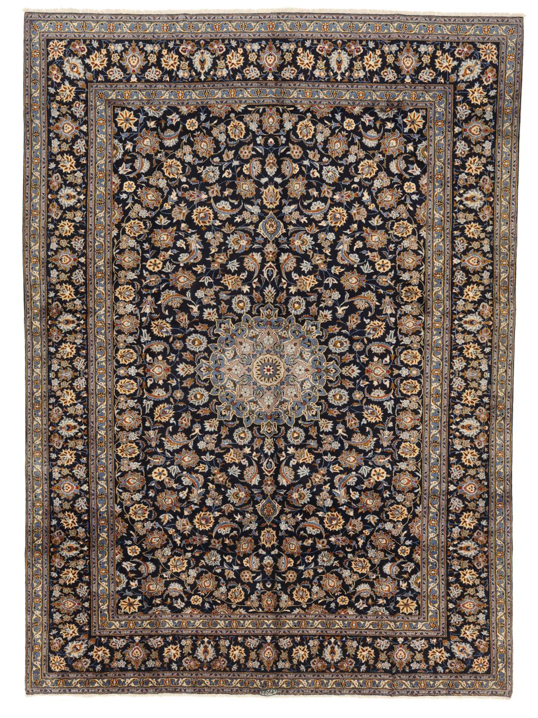 A large, hand-knotted Keshan rug from the Middle East in dark-blue with a central medallion.