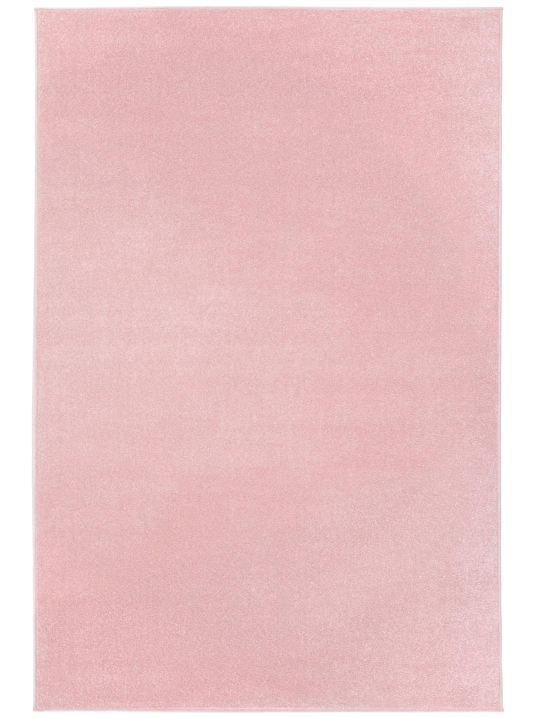Um tapete cor-de-rosa claro sólido com uma textura suave.