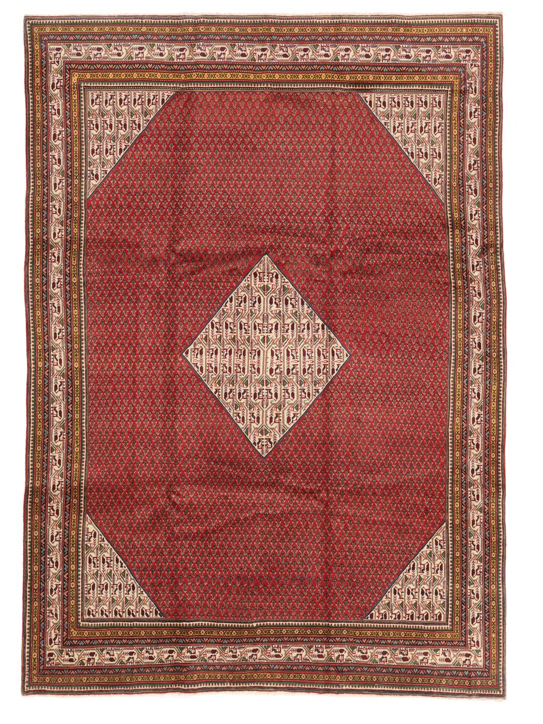 A large, hand-knotted Sarough Mir rug with a vibrant red field and geometric motifs.