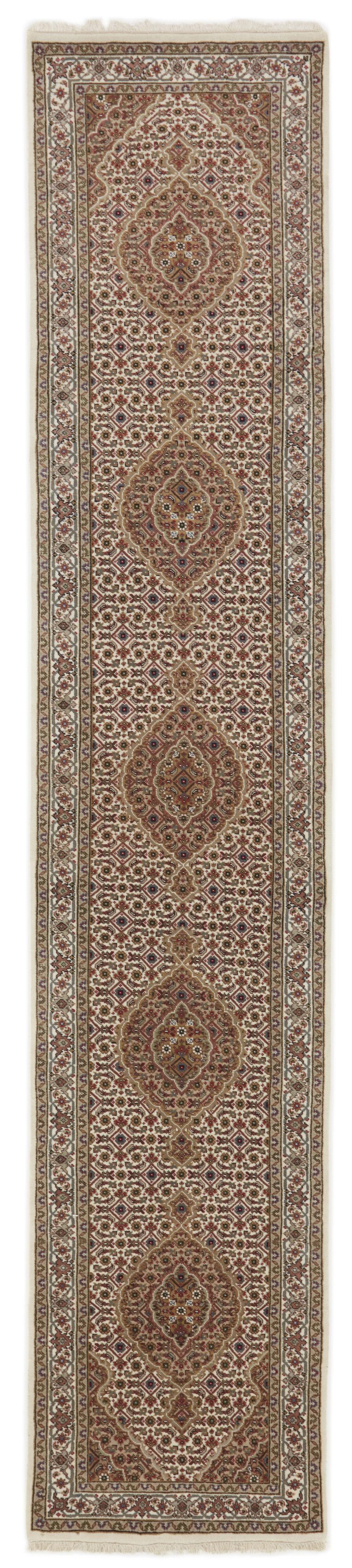 A hand-knotted Tabriz runner from India with a beige background and floral medallion patterns.