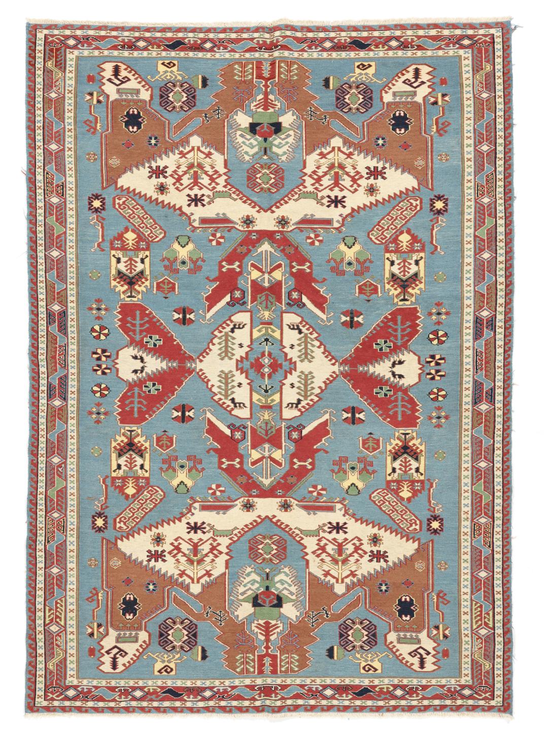 Håndvævet afghansk Kelim-tæppe med blåt felt og ornamenterede geometriske motiver.