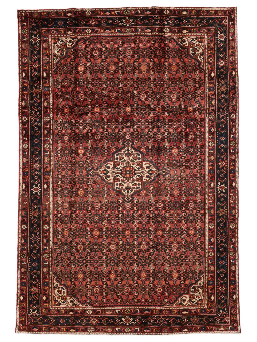 A hand-knotted Hosseinabad rug from the Middle East featuring a dark-red field and intricate patterns.