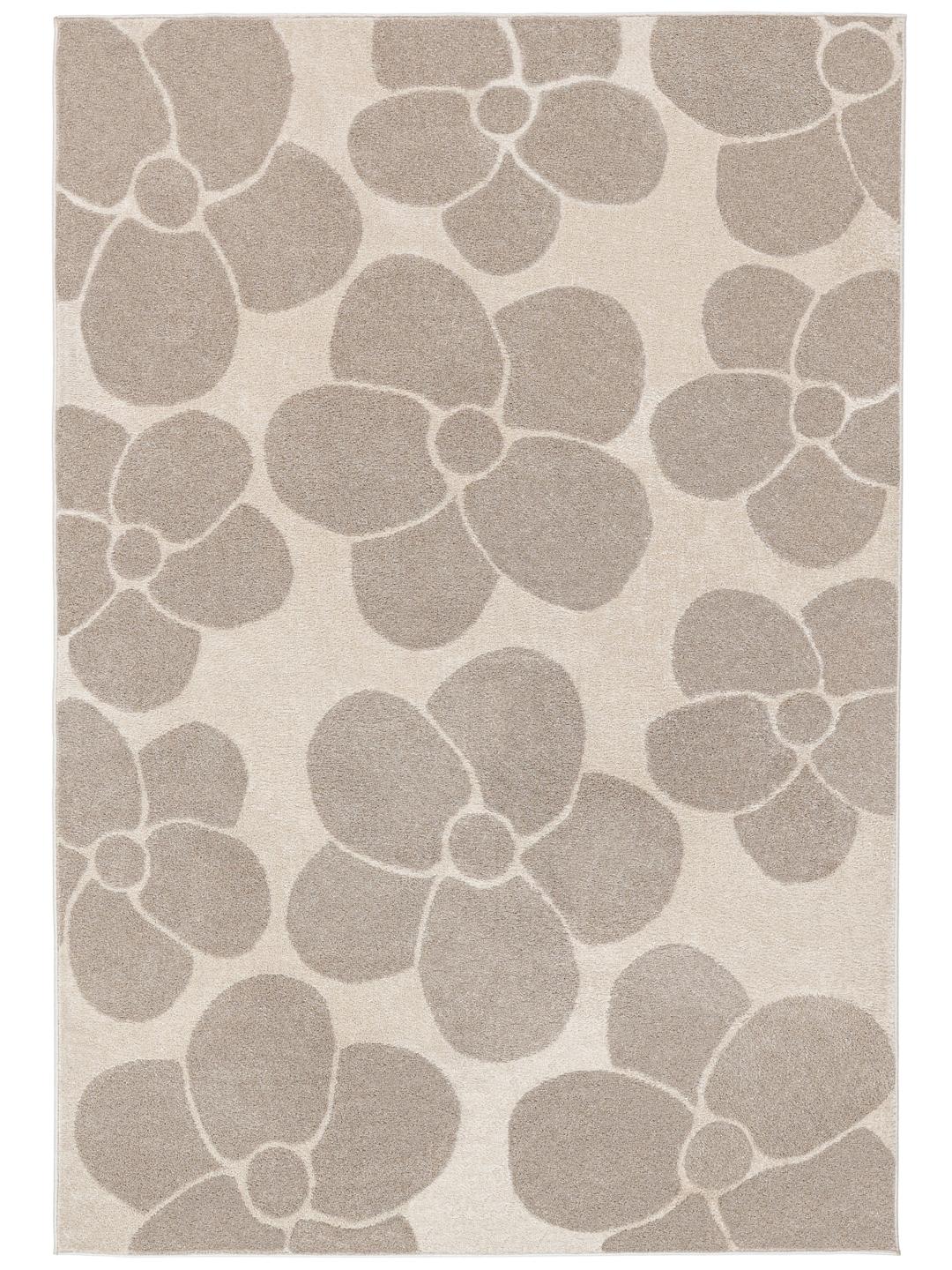 Een beige en gebroken wit bloementapijt met een zachte pooltextuur.