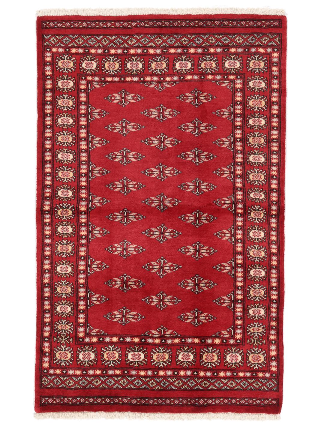 A hand-knotted Pakistan Bokhara rug with a deep red field and traditional geometric motifs.