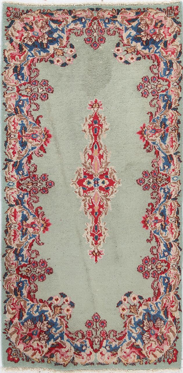 Antique Kerman rug from the Middle East in light-green with floral motifs