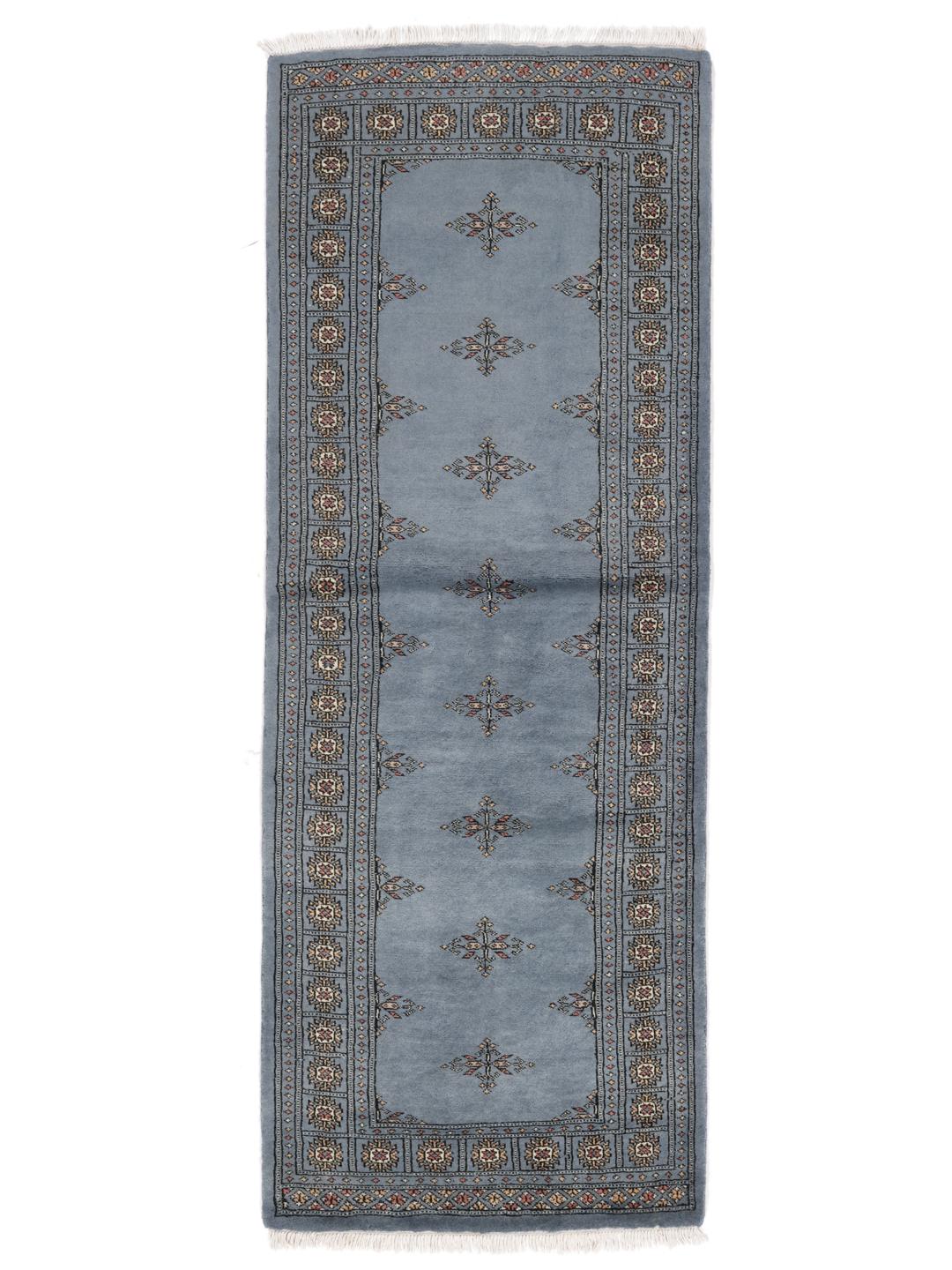 A hand-knotted blue runner from Pakistan with a traditional motif