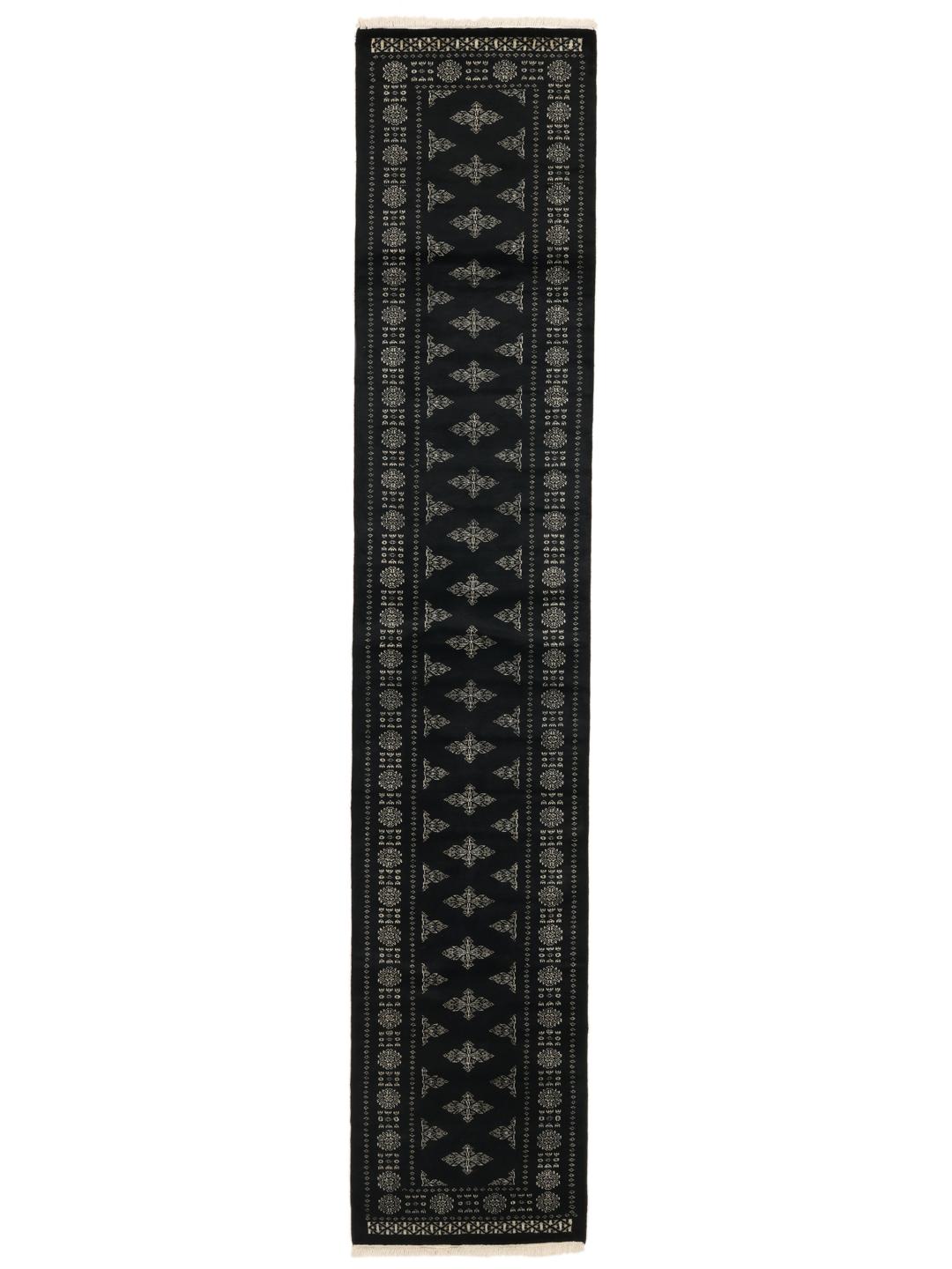 Hand-knotted Pakistan Bokhara runner with intricate motifs on a black background