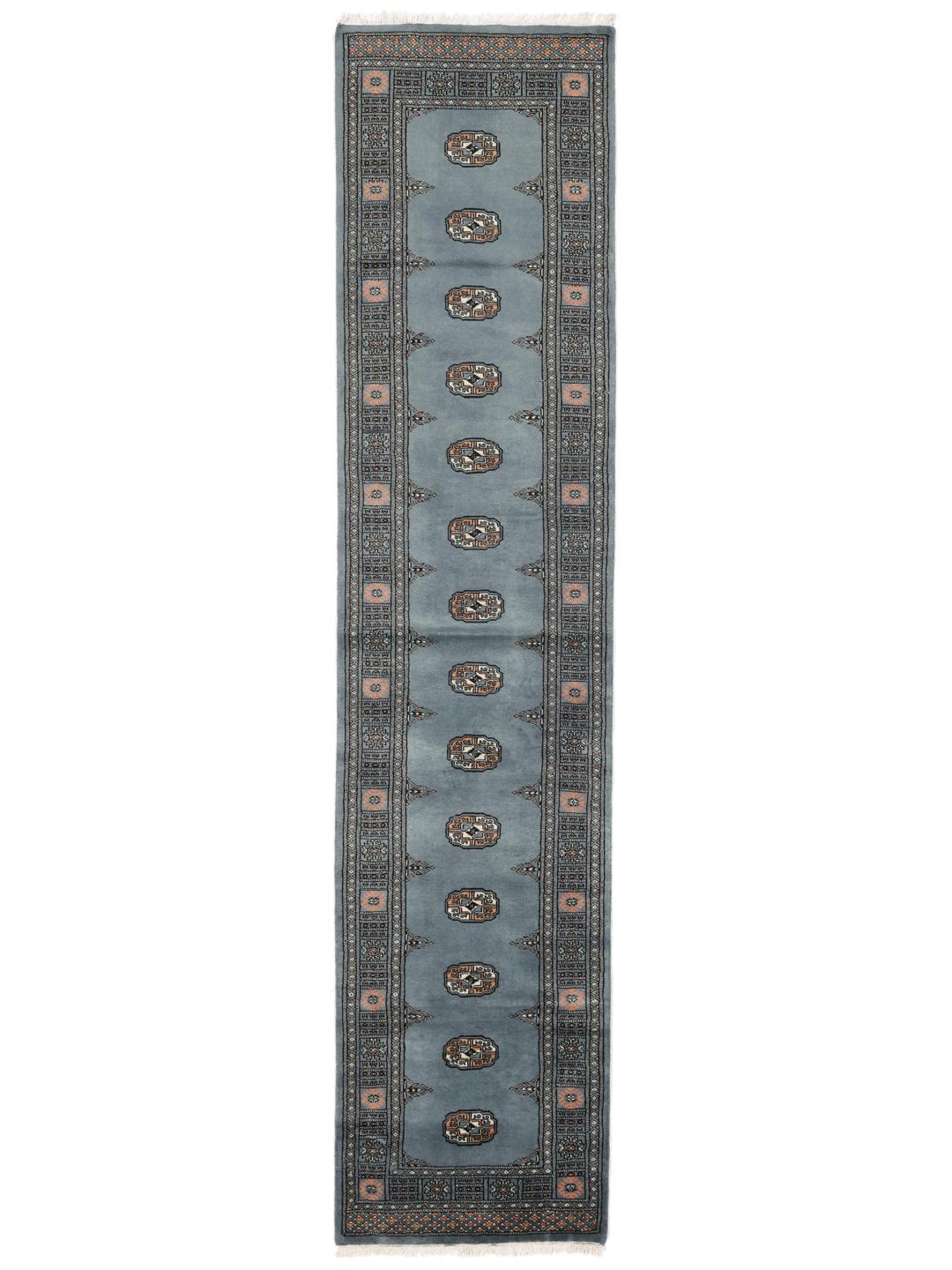 Hand-knotted blue runner from Pakistan featuring traditional repeating motifs