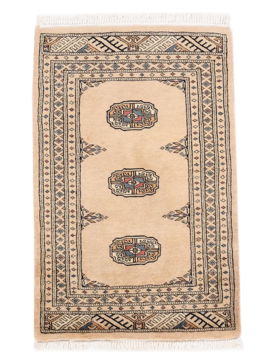 A hand-knotted Pakistani Bokhara rug in beige with traditional medallion motifs.