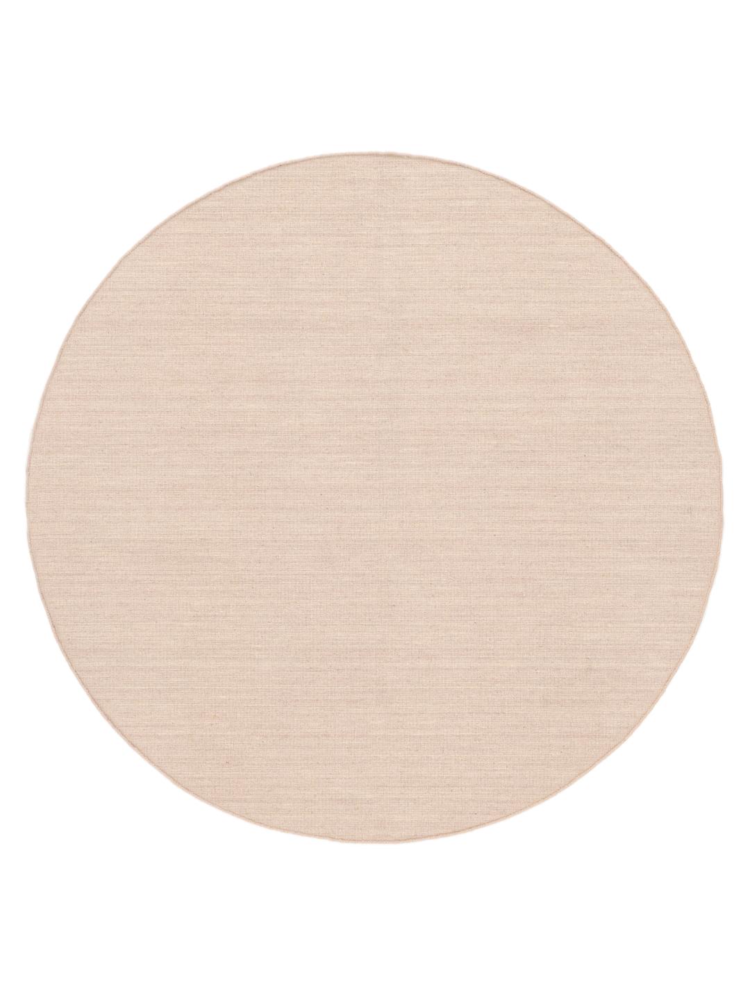 Round light pink rug with a simple woven texture