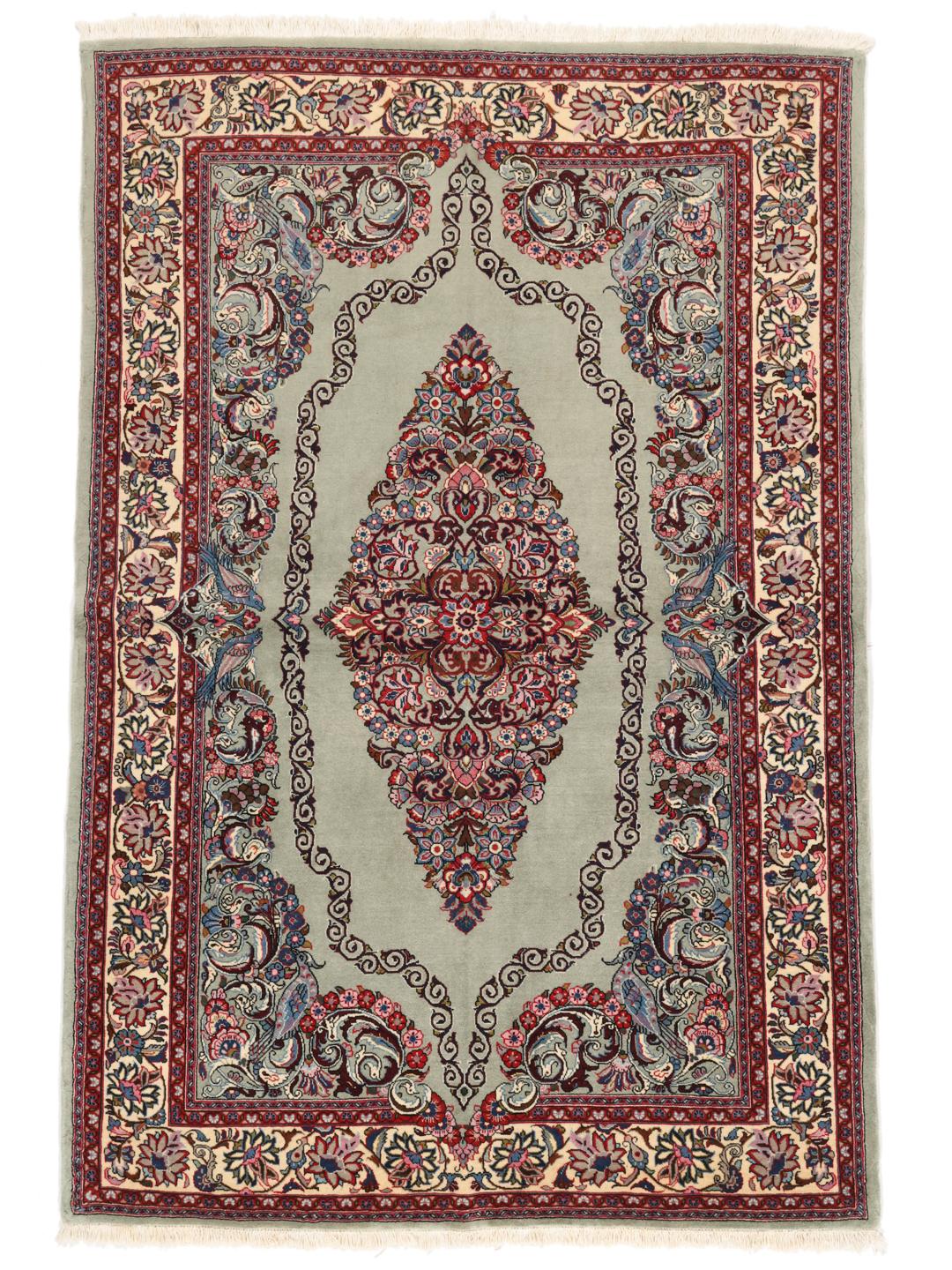 A hand-knotted Sarough rug from the Middle East with a light-green field and intricate floral medallion.