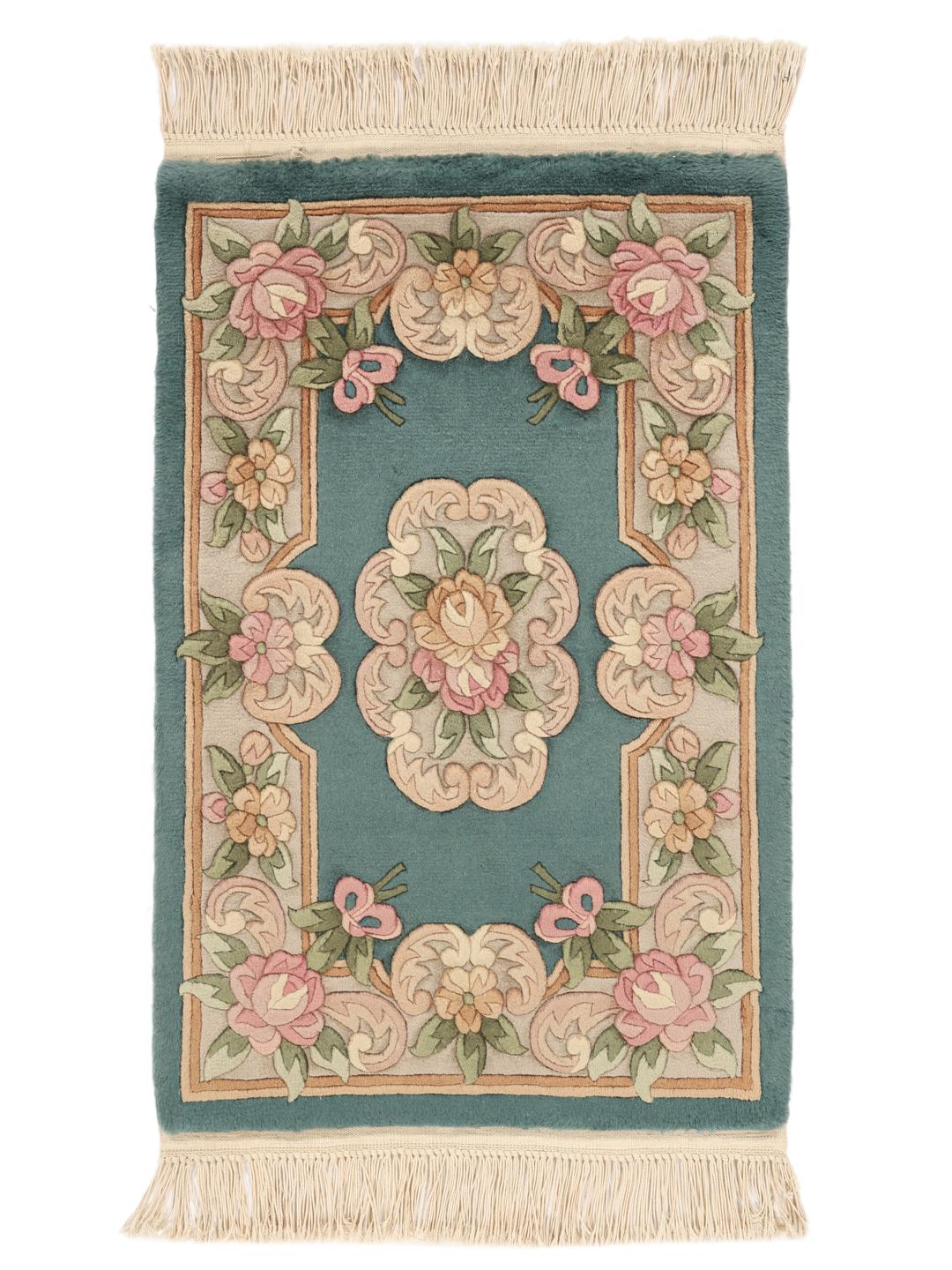 Et rektangulært kinesisk tæppe med blomstermønstre i nuancer af teal, lyserød og beige.