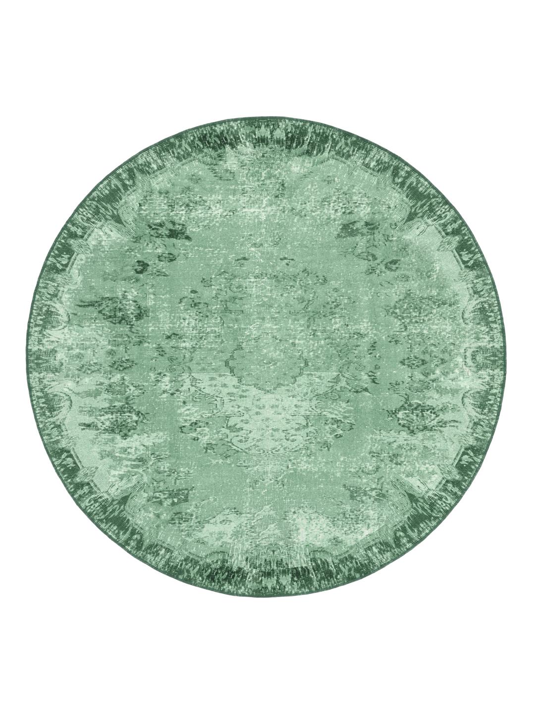 Rond groen vloerkleed met een verweerd patroon