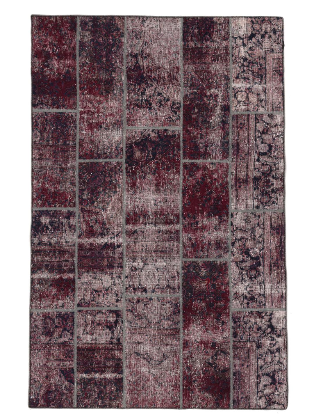 A rectangular patchwork rug from the Middle East featuring a dark-red and dark-blue colour palette.