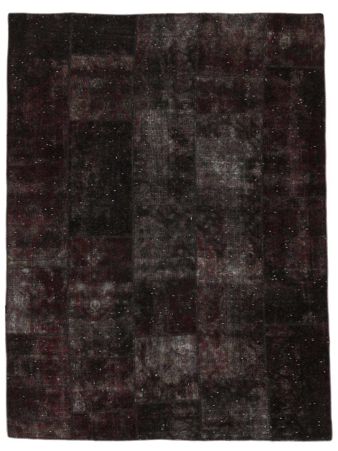 A large rectangular patchwork rug with dark-grey and dark-red tones, Middle Eastern origin.