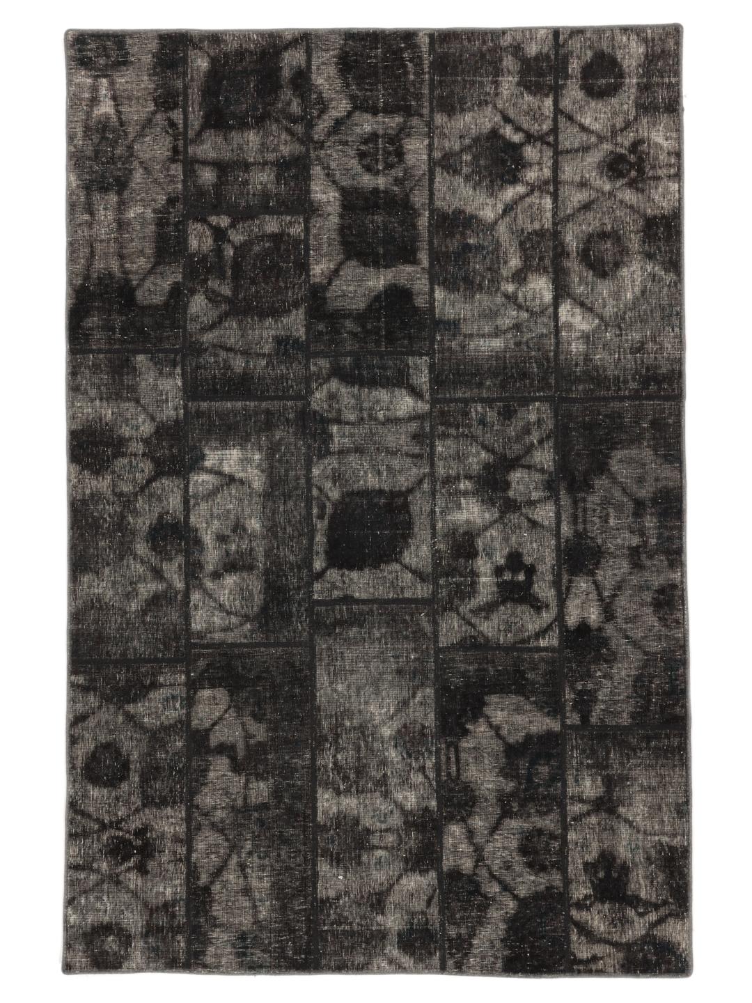 A unique patchwork rug with black and grey tones from the Middle East