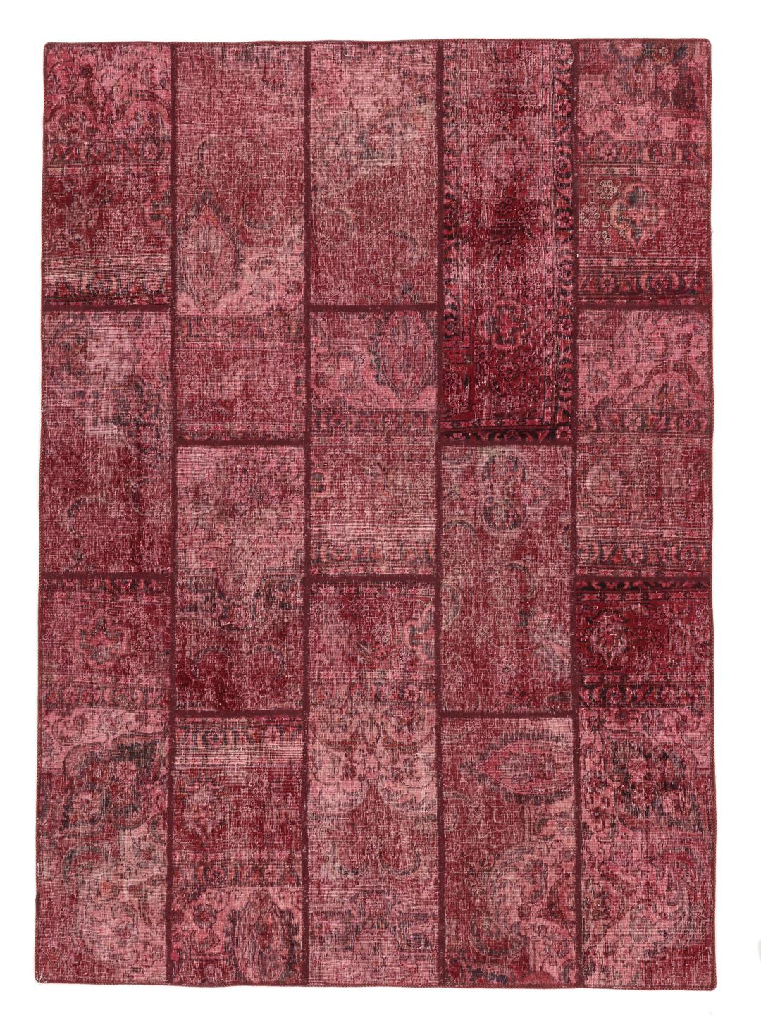 A handcrafted patchwork rug from the Middle East featuring a vibrant dark-red colour palette.