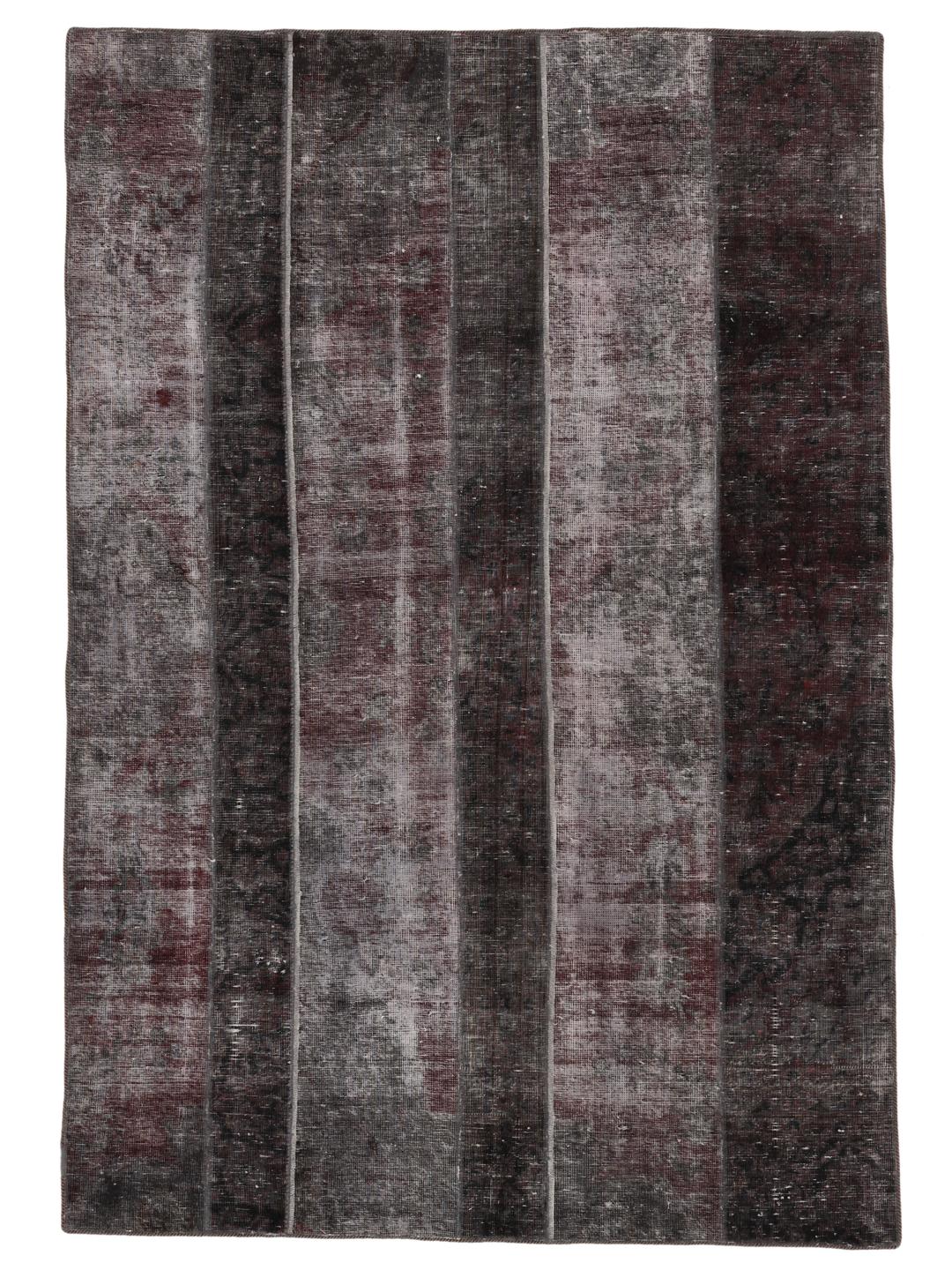 A rectangular patchwork rug featuring vertical stripes in dark-grey and deep red tones, of Middle Eastern origin.