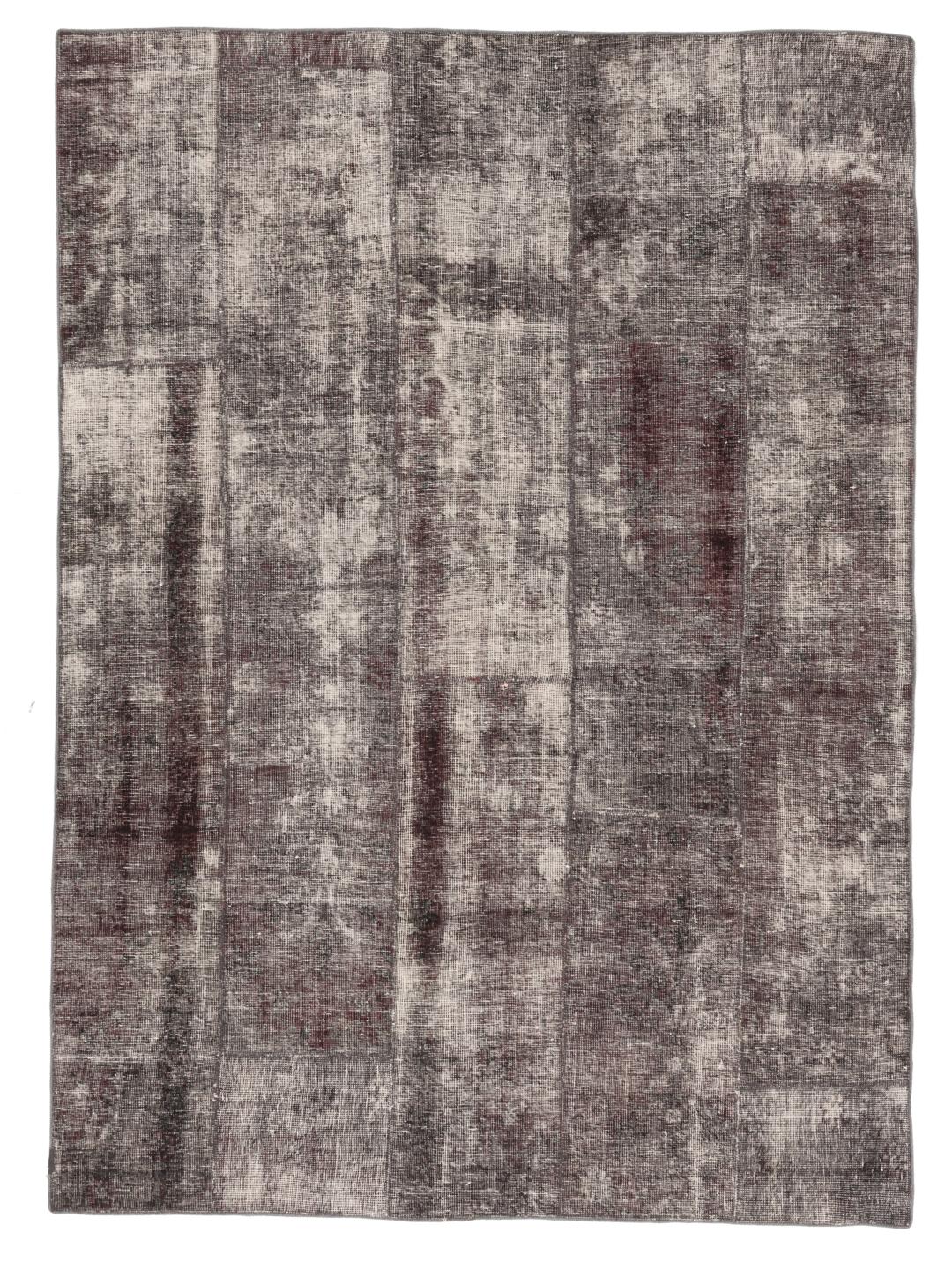 A unique, hand-knotted patchwork rug from the Middle East in dark-grey tones.