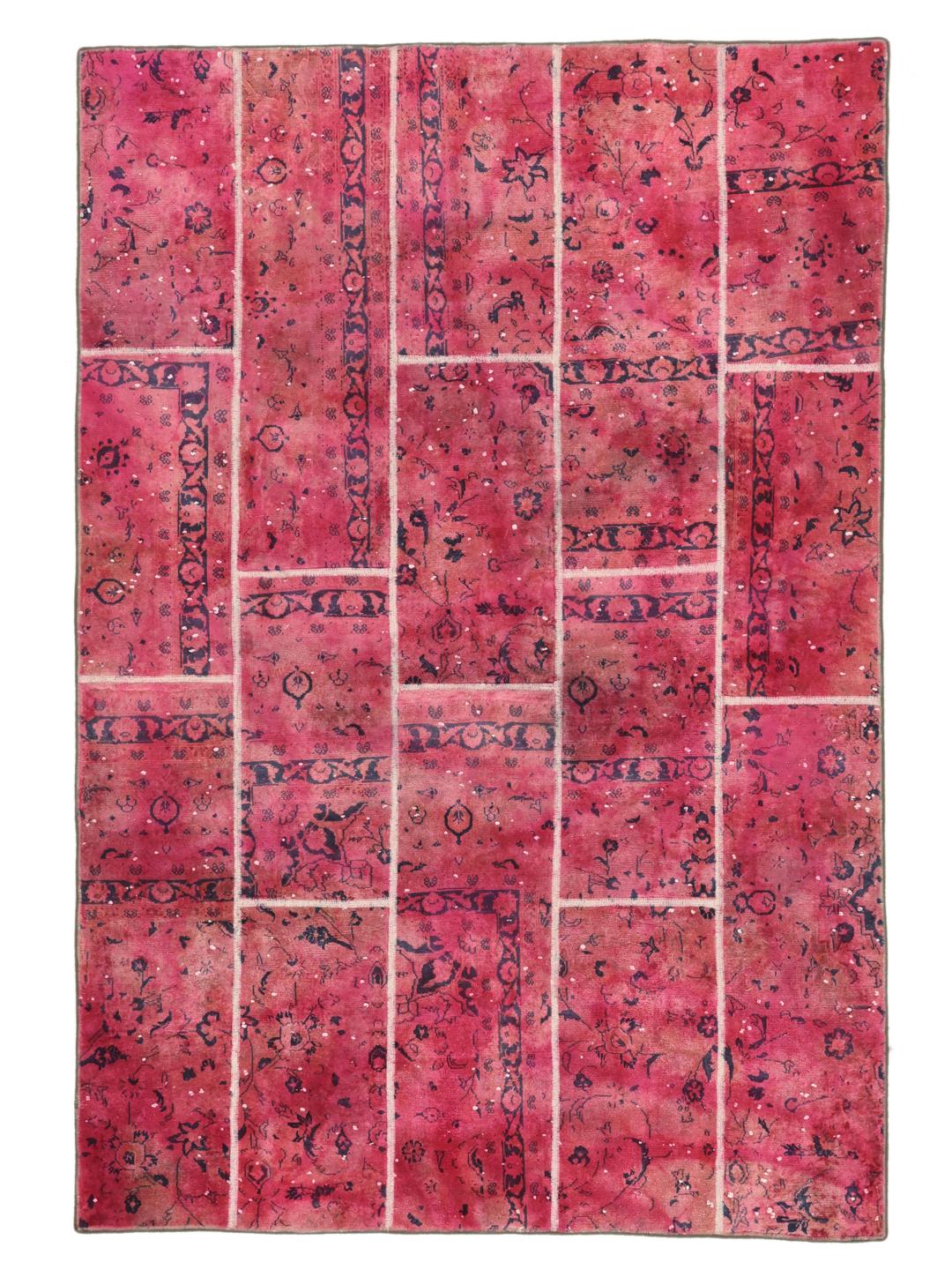 A vibrant dark-pink patchwork rug with Middle Eastern inspired motifs