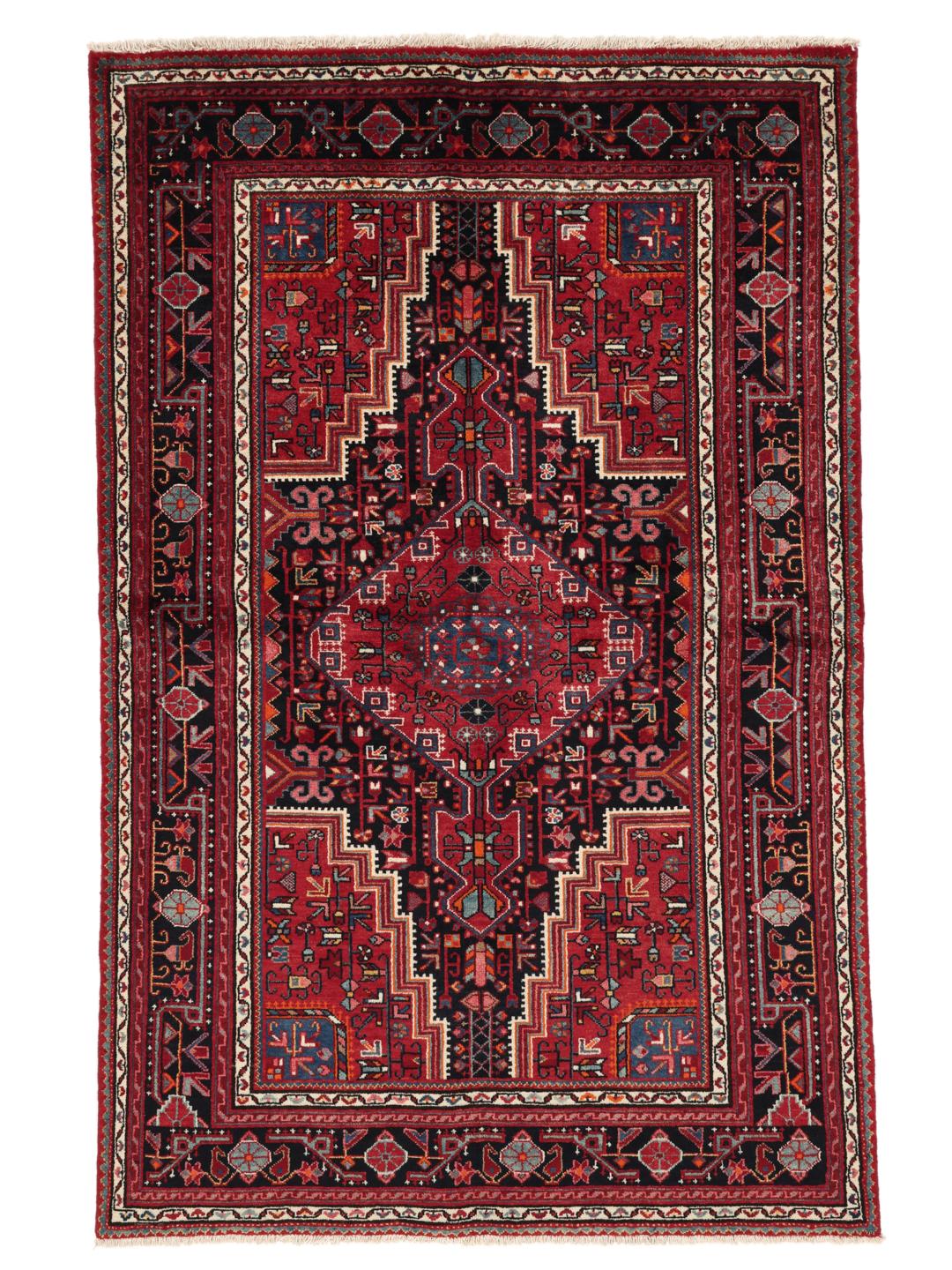 A hand-knotted Toiserkan rug from the Middle East featuring a dark-red and black geometric medallion design.