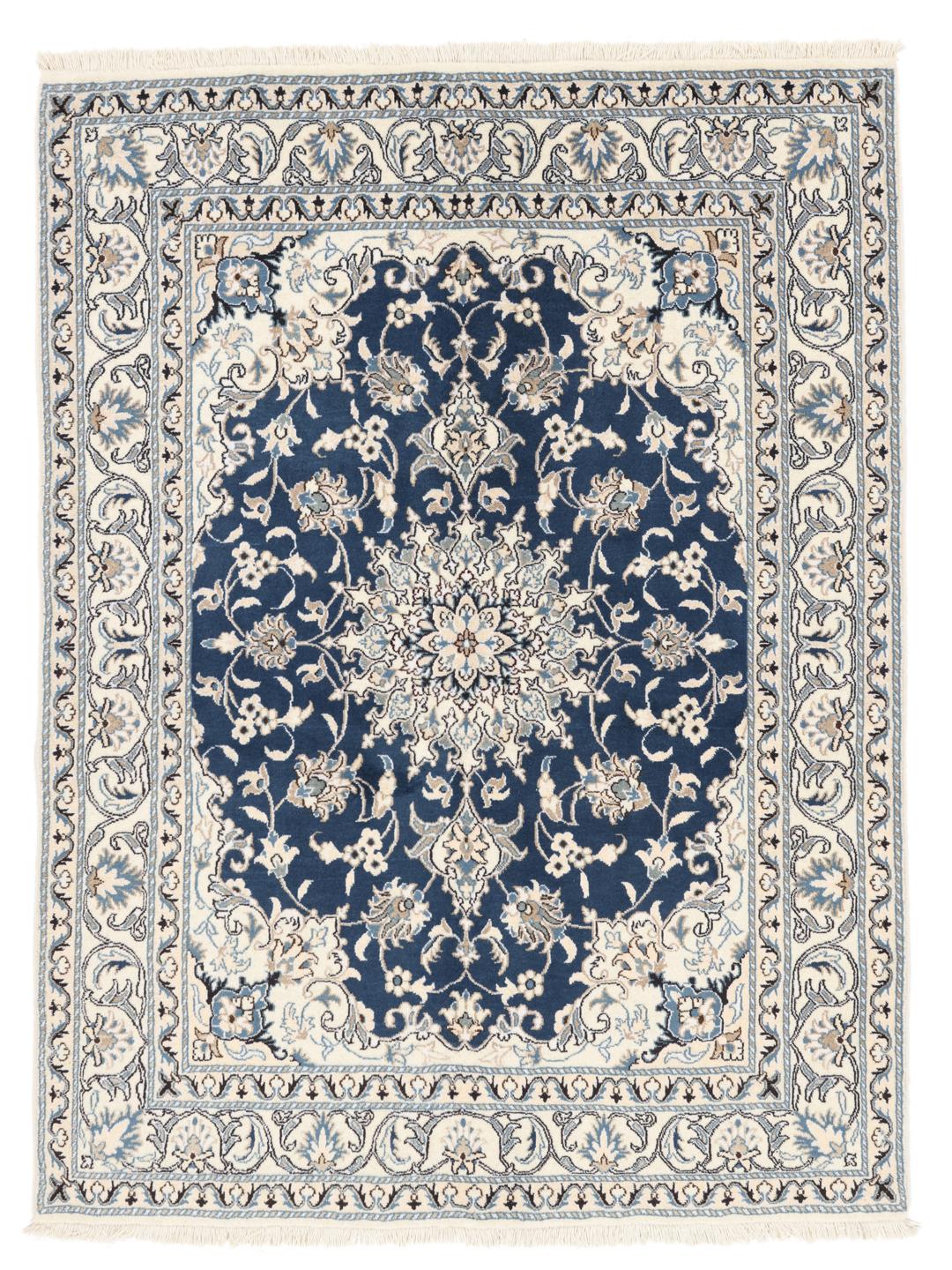 A hand-knotted Nain rug from the Middle East featuring a blue field with ivory floral patterns.