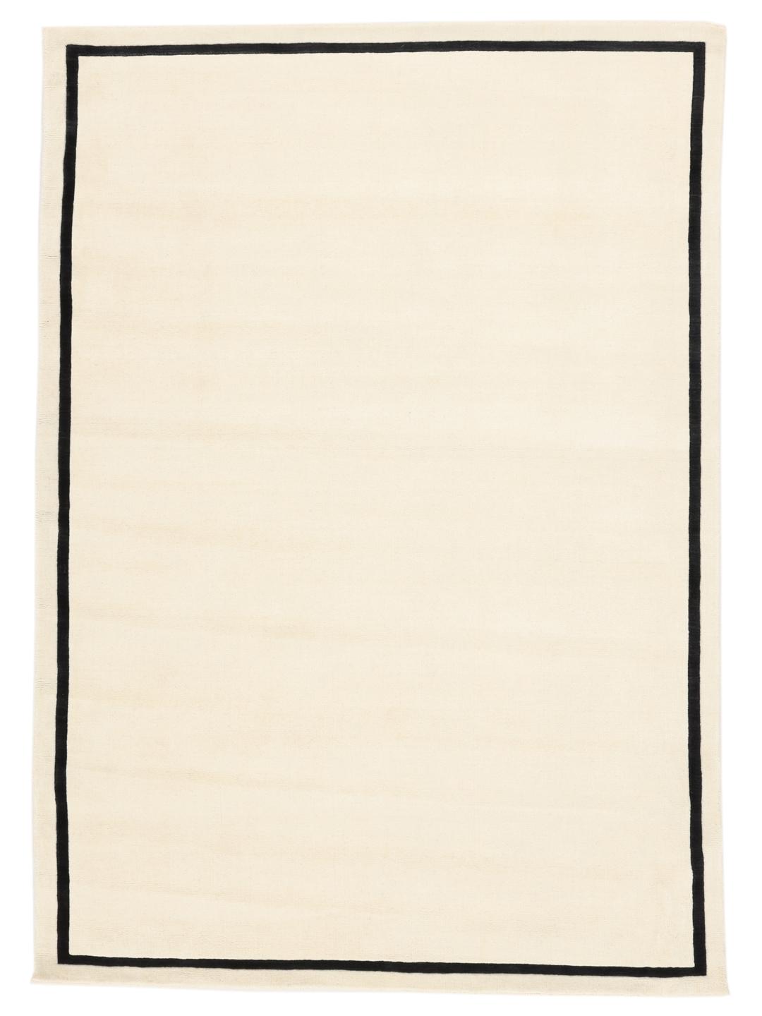 Hand-woven minimalist rug from India with a beige field and dark border
