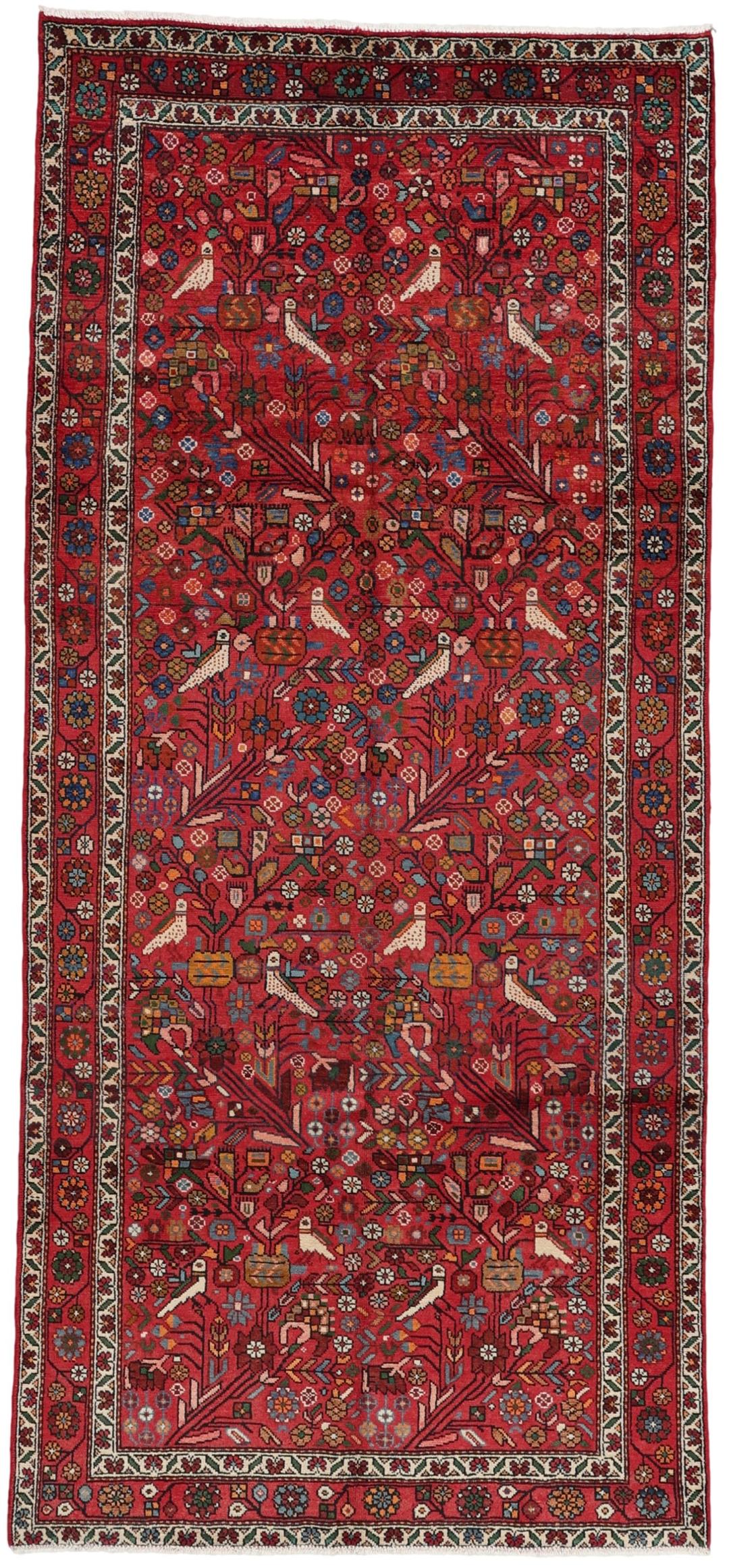 A hand-knotted Hamadan rug from the Middle East with a vibrant red field and bird motifs.