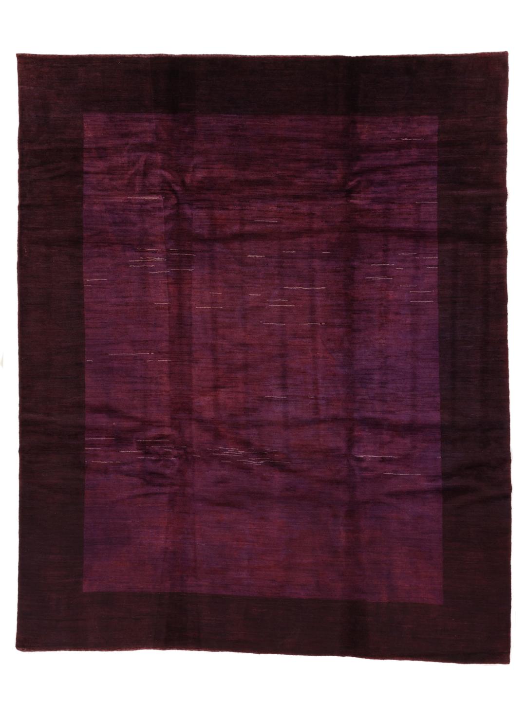 A hand-knotted Gabbeh Fine rug from the Middle East in deep purple tones.