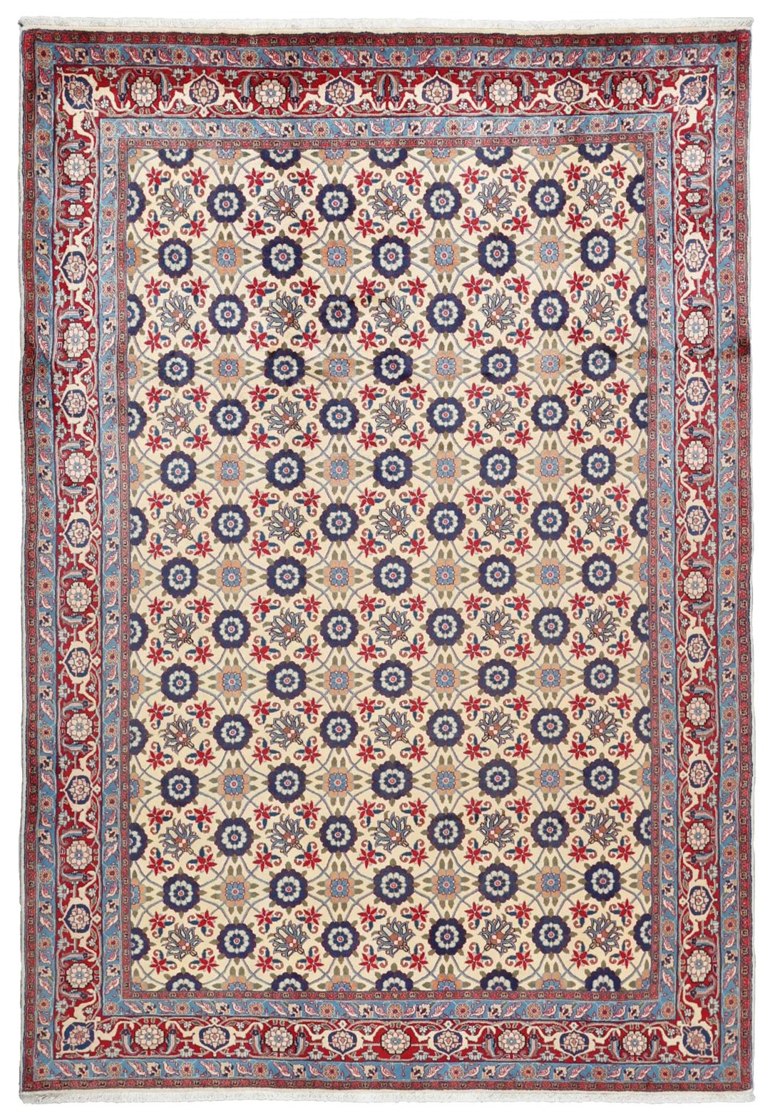 A rectangular Varamin rug from the Middle East with a beige field and red and blue floral patterns