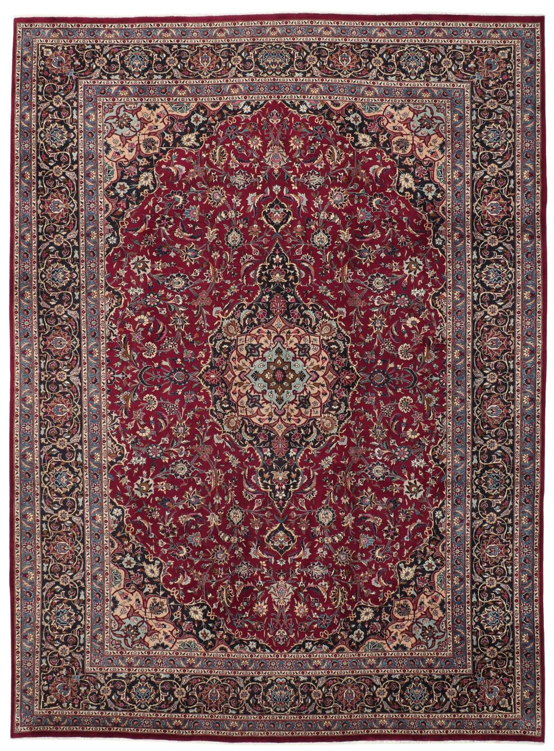A hand-knotted Mashad rug from the Middle East with a deep red field and intricate floral medallion.