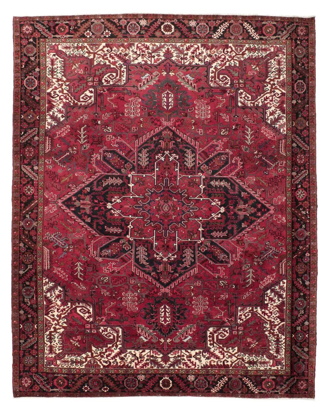 A hand-knotted Heriz rug from the Middle East in deep red and dark tones.