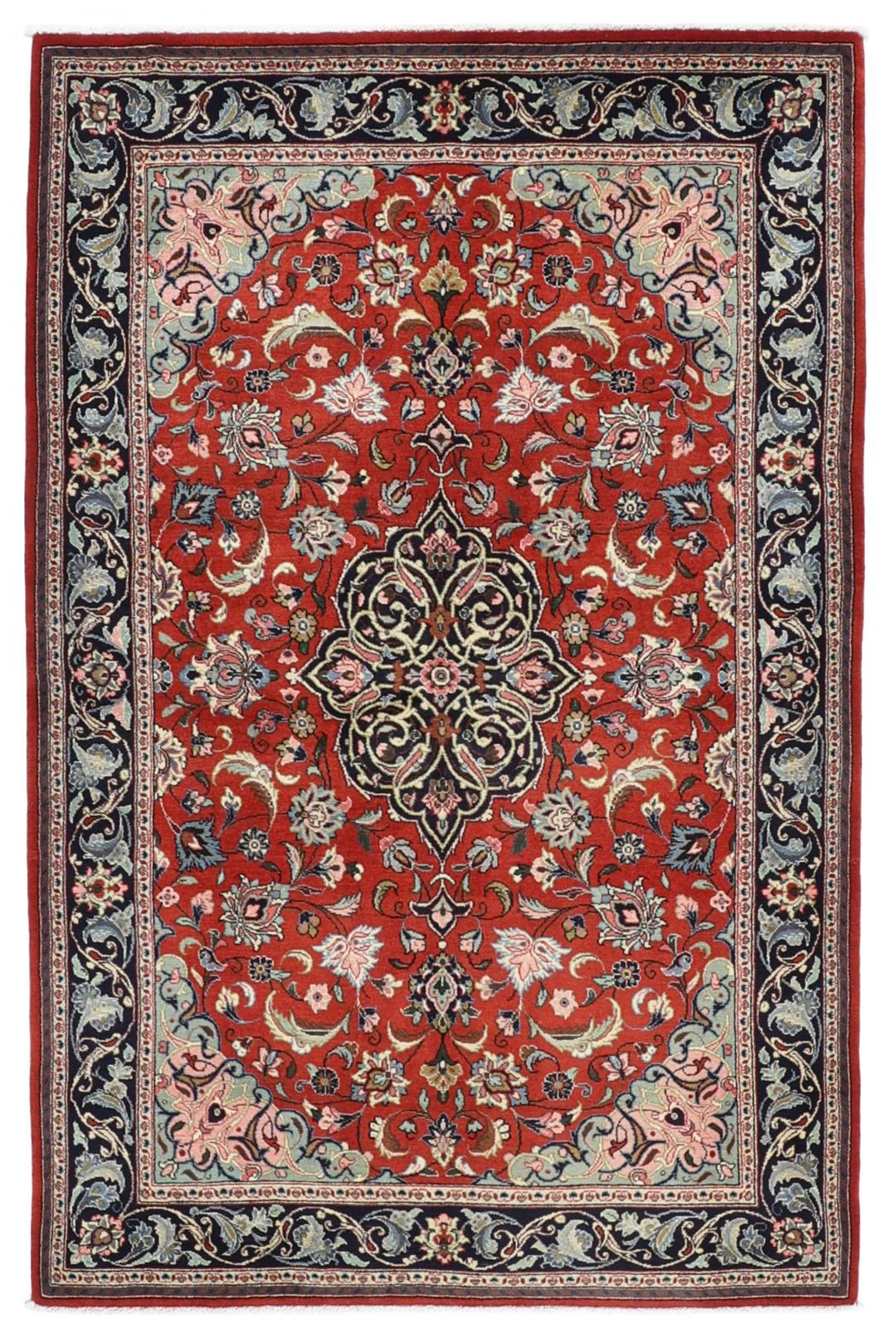 Hand-knotted Sarough rug from the Middle East with a red field and floral patterns.